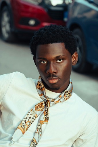 Young man with scarf and white shirt