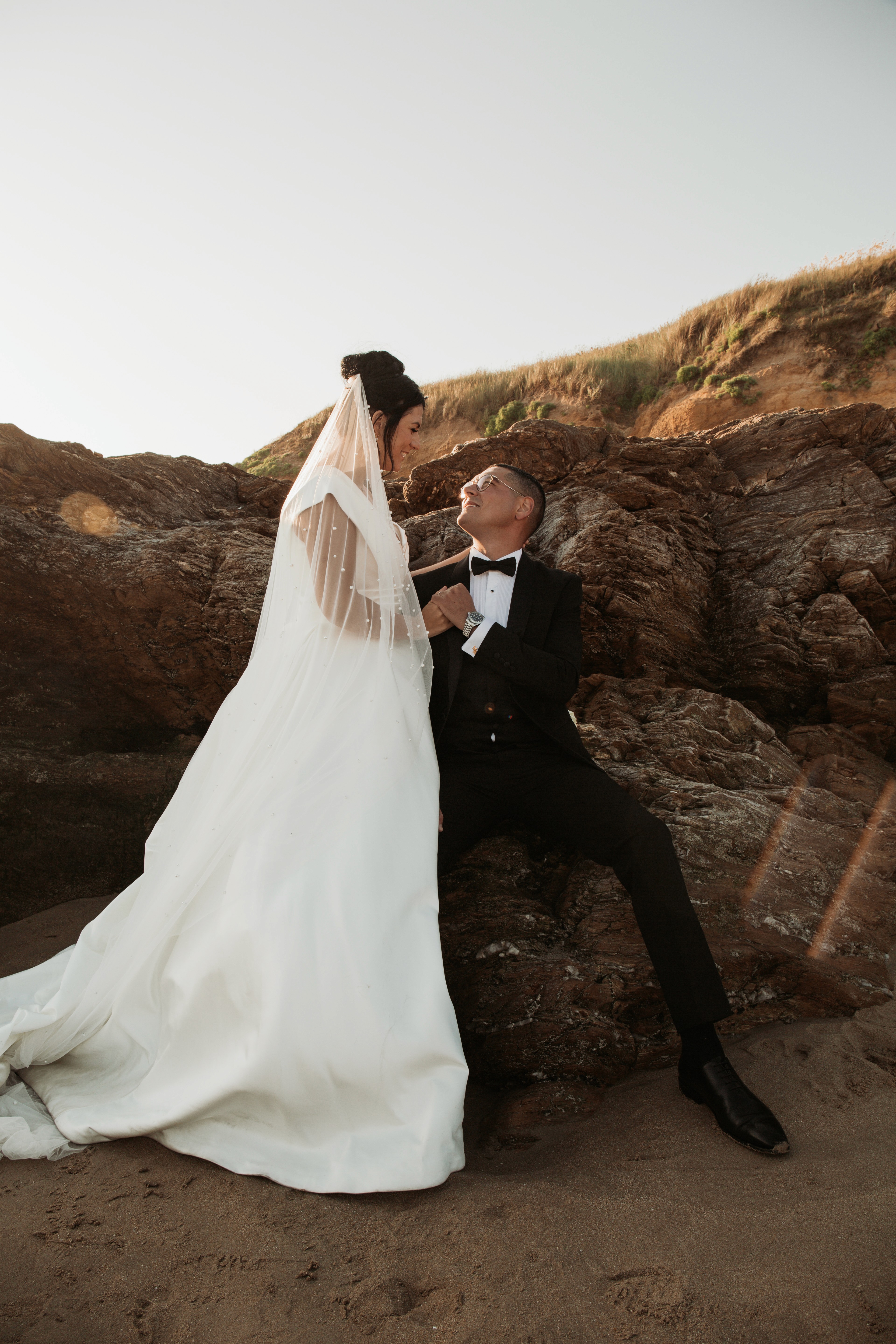Stylish individual with platinum blonde hair, sunglasses, and leather outfit