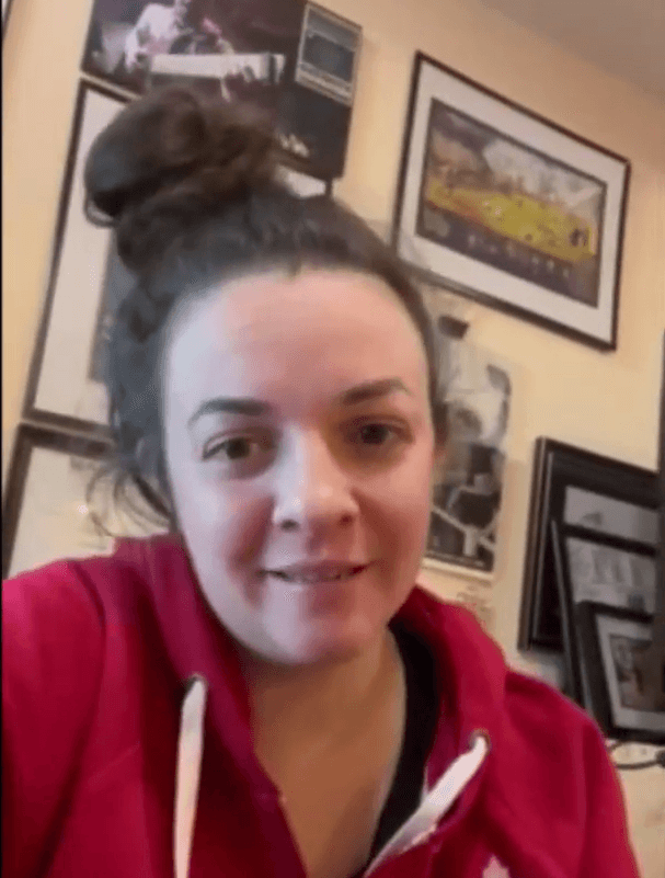 Close-up of lush, dark green leaves, some glossy and wet, against a muted background.
