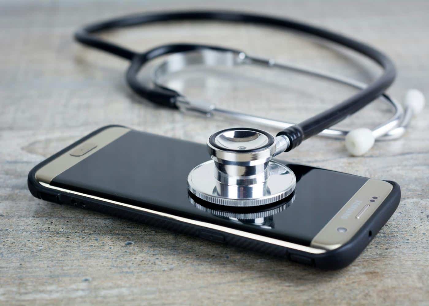 A stethoscope on top of a smart phone