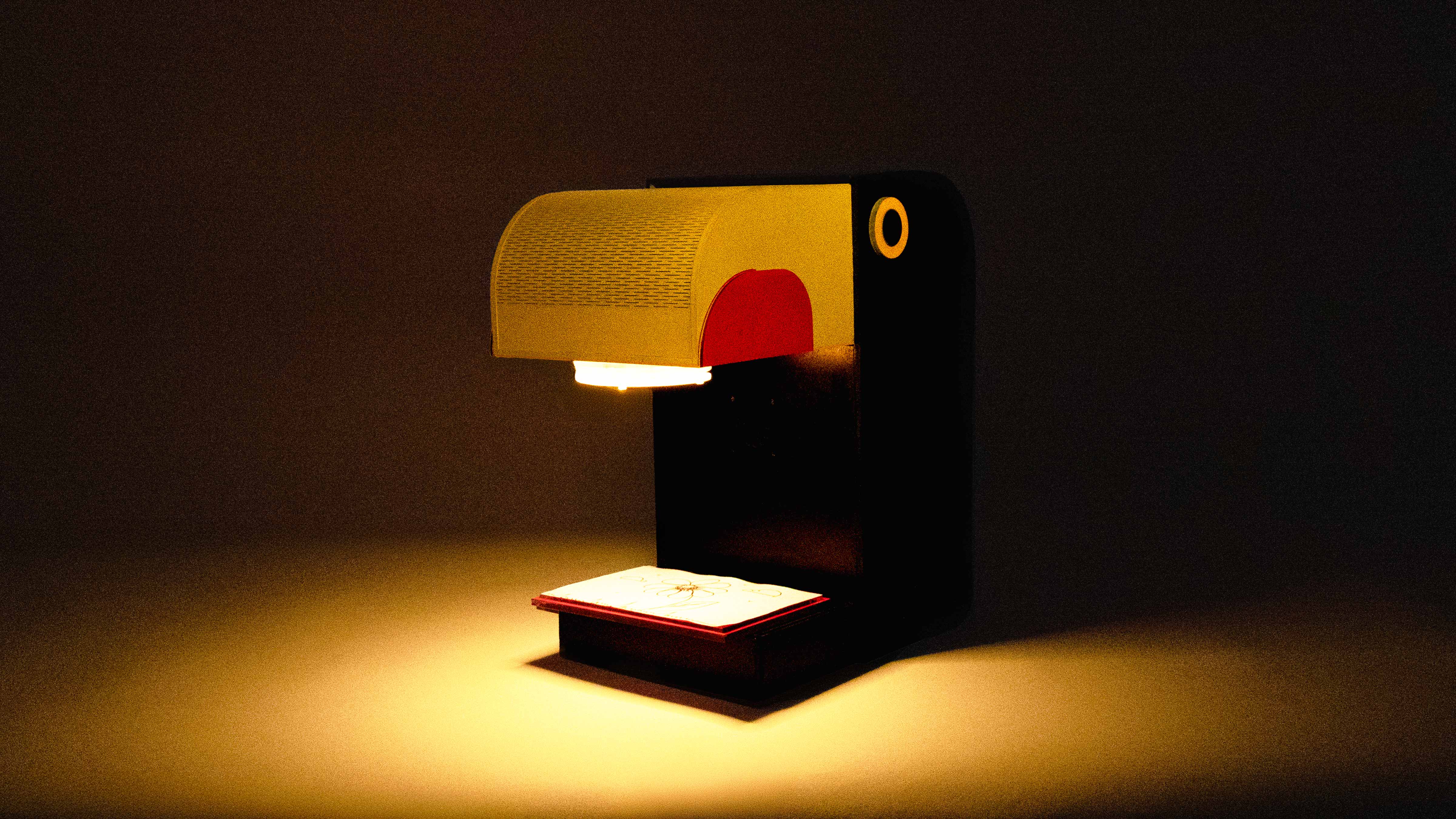 The Sketch Tales lamp lighting a card on a dark table
