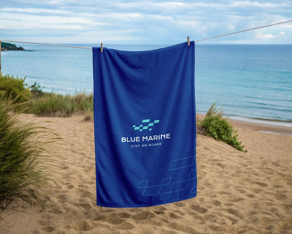 Application of the Blue Marine identity on a towel, reinforcing brand consistency across touchpoints