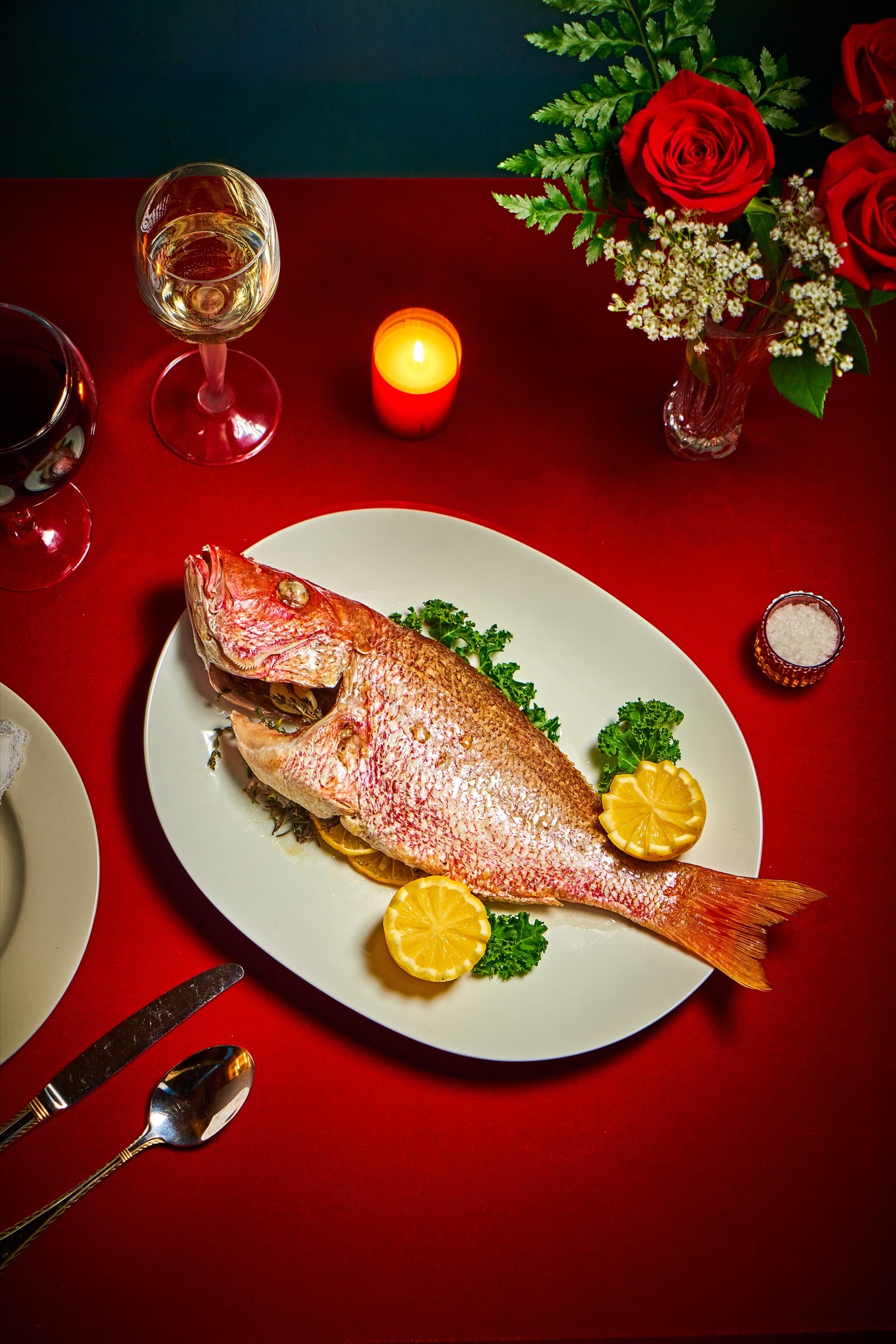 Whole fish plated on a red tabletop for Paddy’s Pub