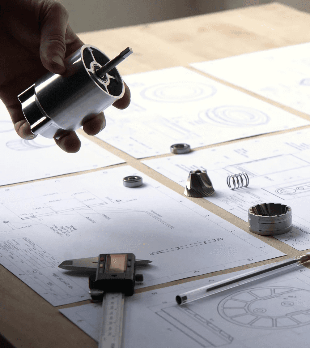 Manufacturing technical drawings for a manual coffee grinder, showing CNC parts ready for evaluation.