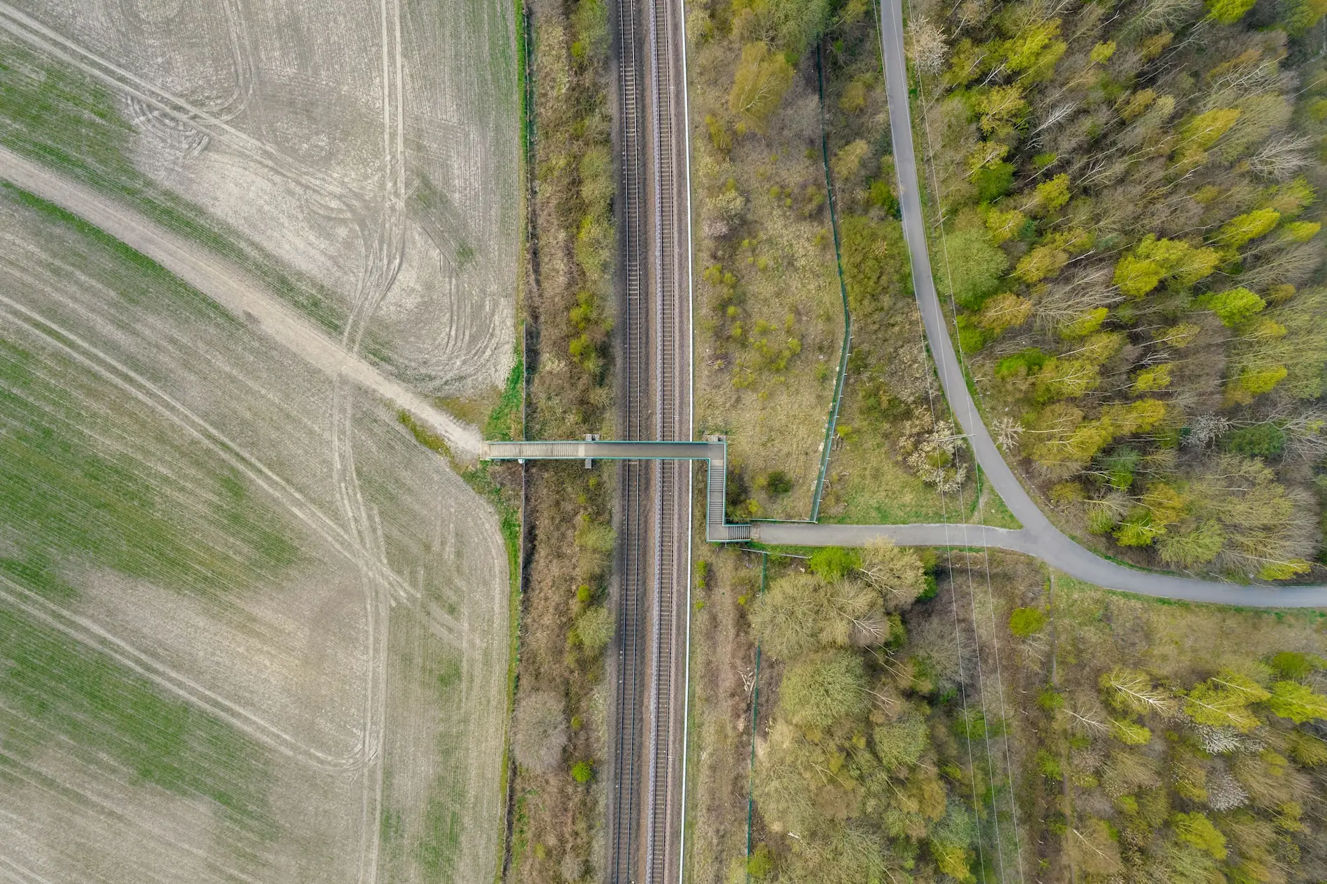 Top-down aerial view of a road bridge crossing a rocky river, suitable for a site planning construction map.