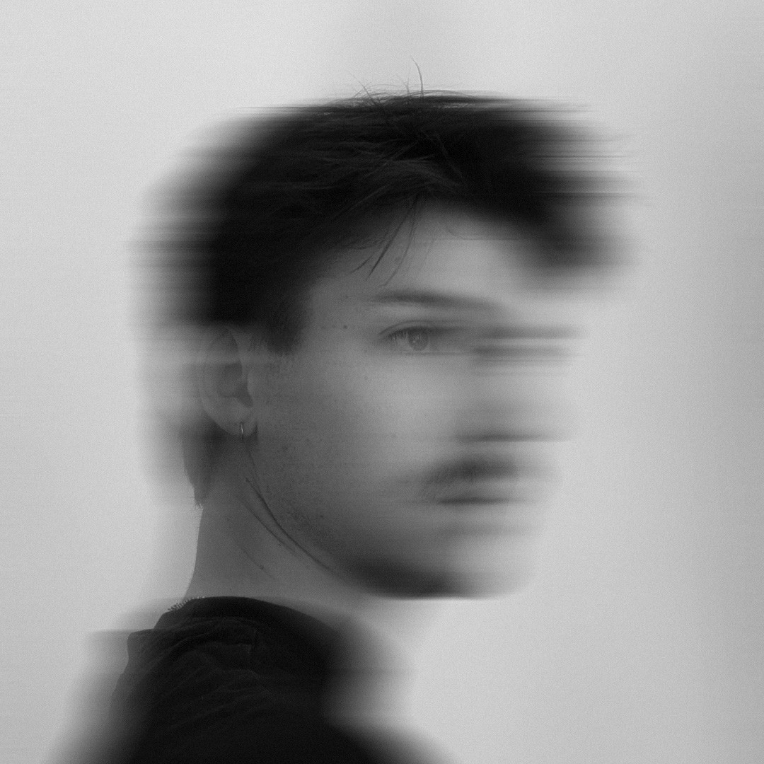 a blurry photo of a person standing in front of a wall