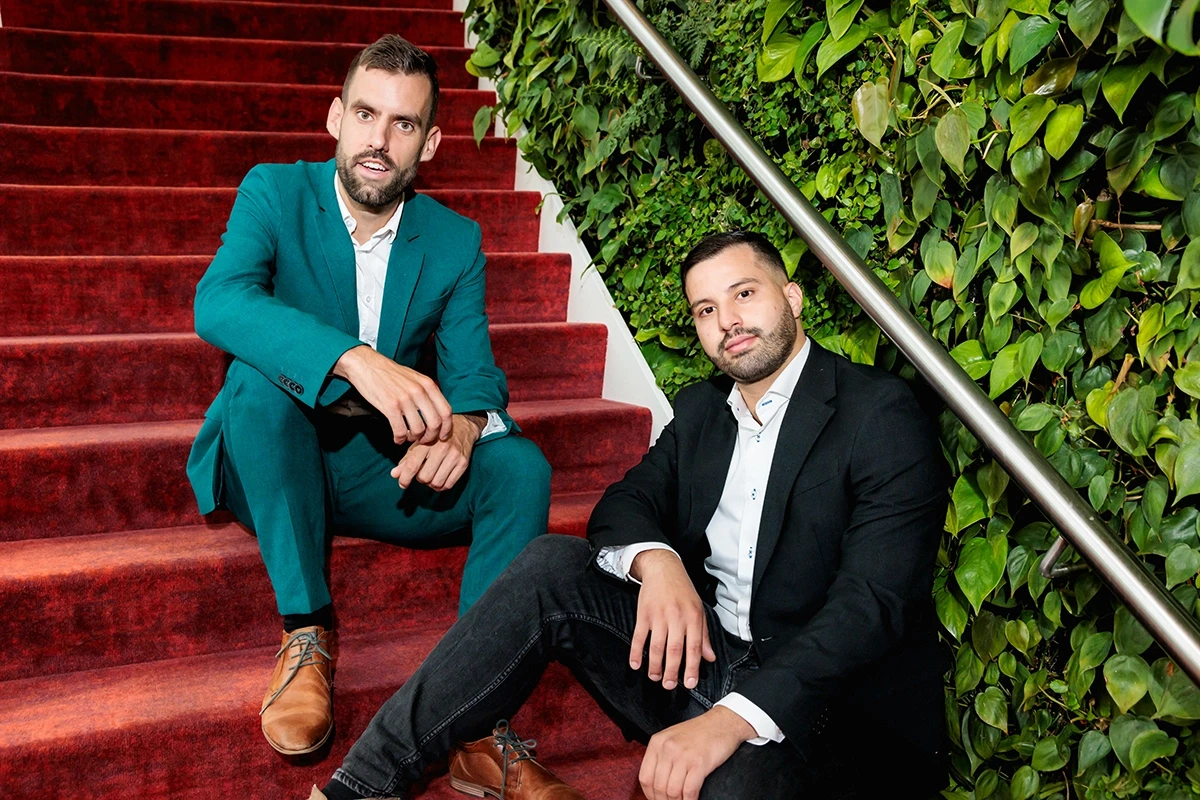 Two AFAS Software colleagues sitting on the red stairs at their office