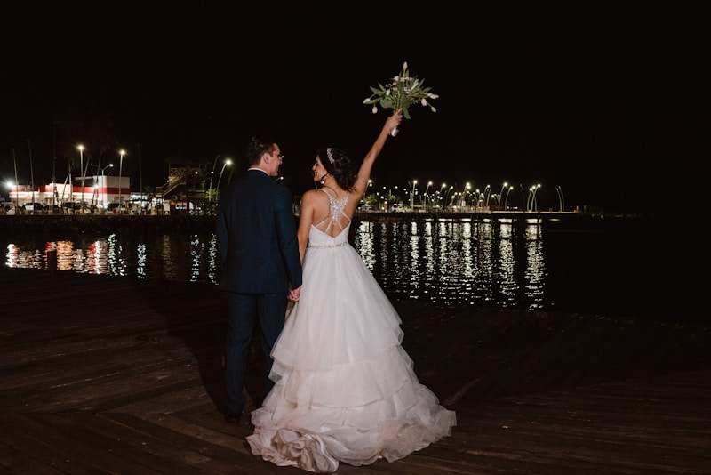 Bride and groom celebrating by the water