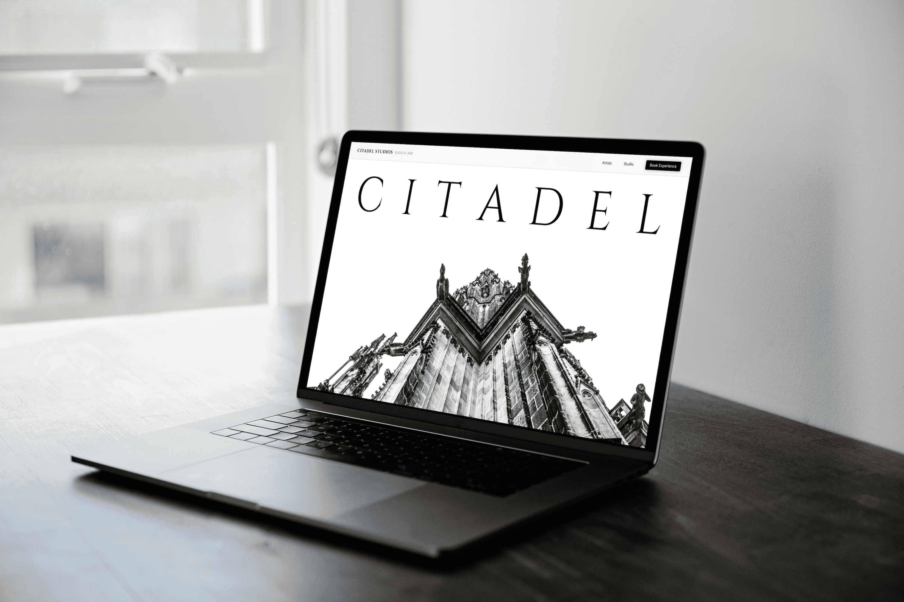 laptop on table by window in day light