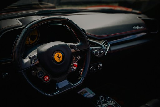 The interior of a car with a steering wheel and dashboard