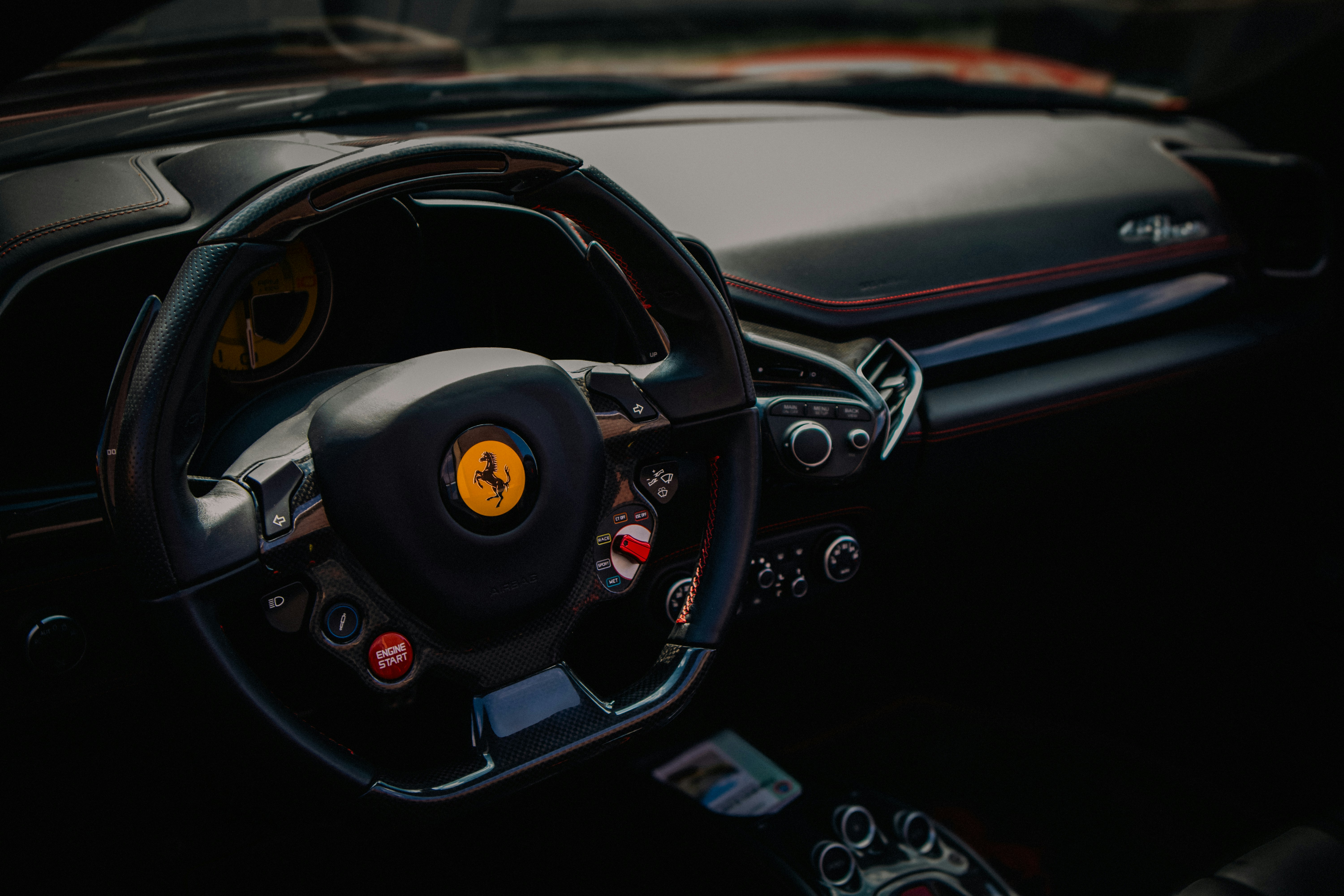 The interior of a car with a steering wheel and dashboard