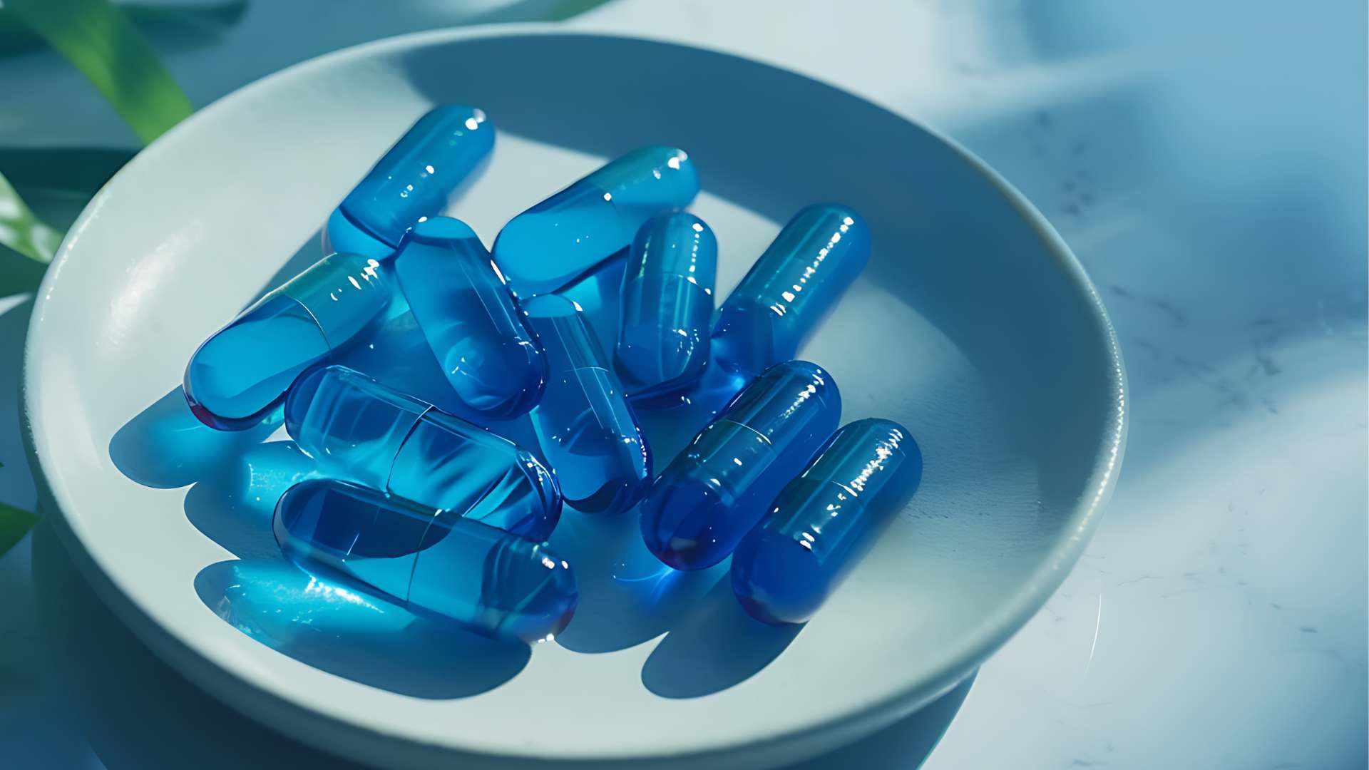 Pile of translucent blue capsules on a white dish