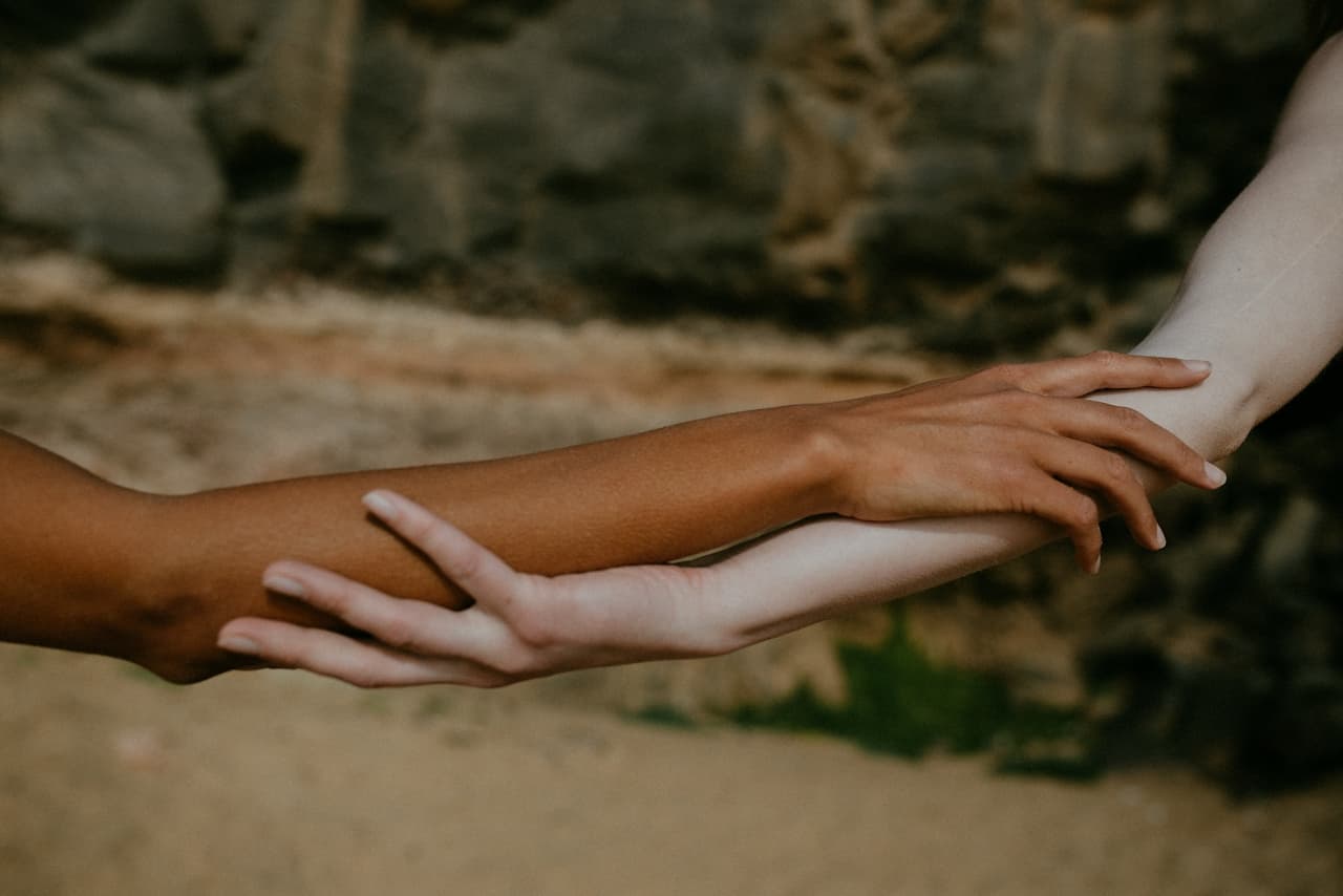 Two arms holding on to each other 