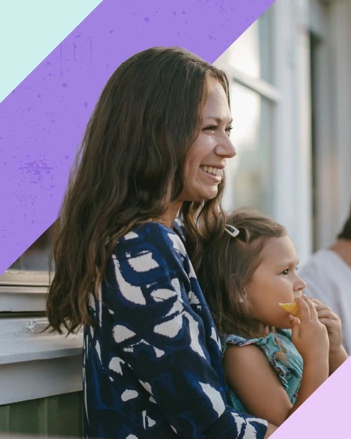 Woman holding baby smiling