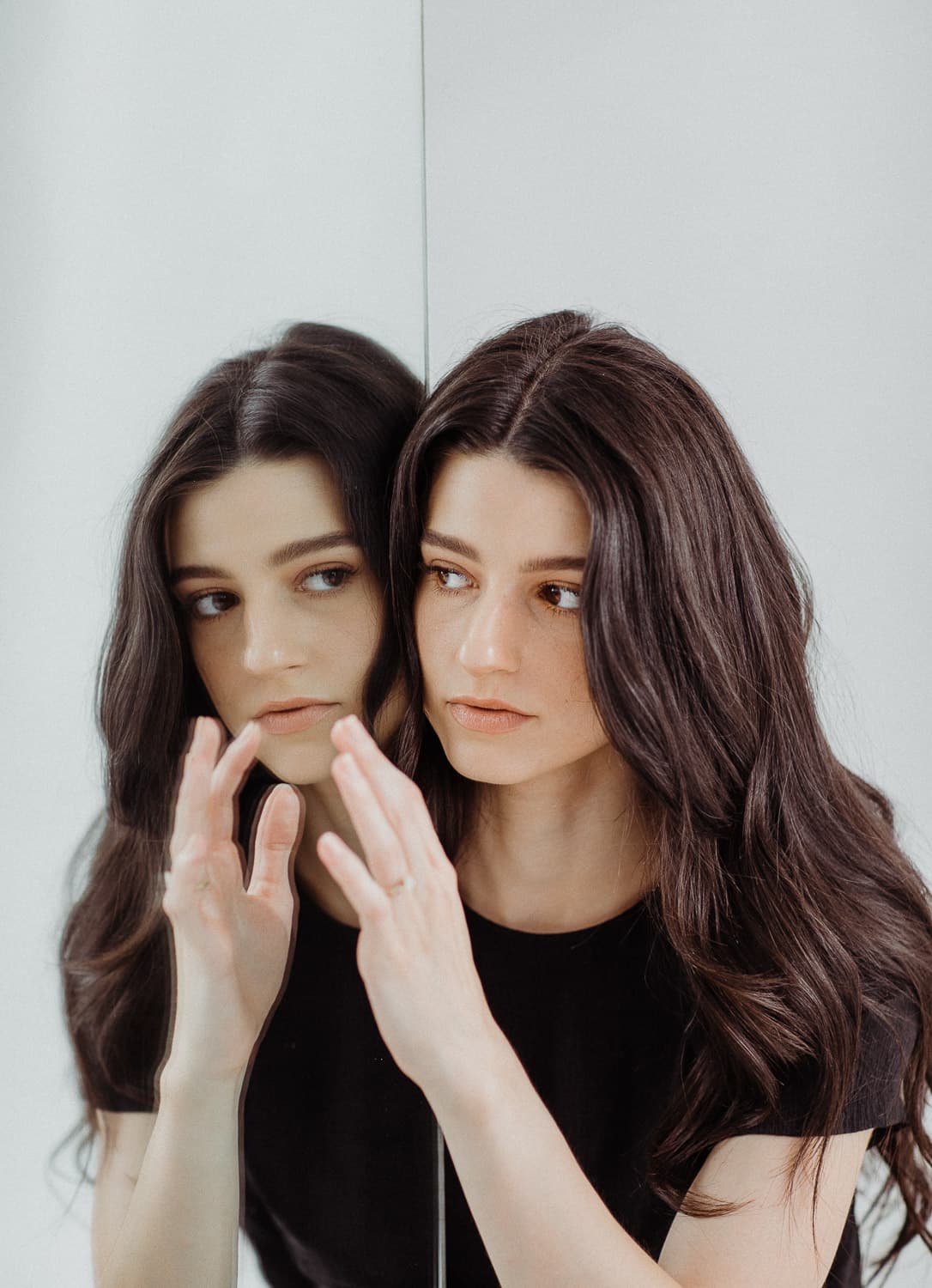 woman standing in front of mirror