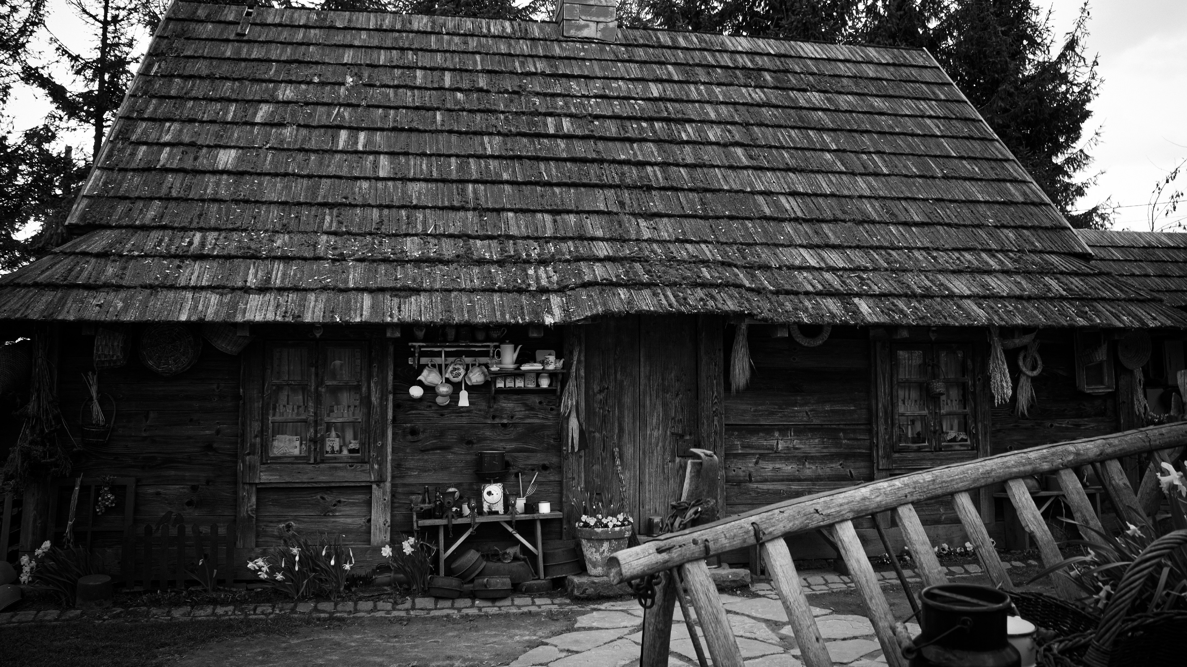 Rustic wooden cabin with shingled roof and porch decorations