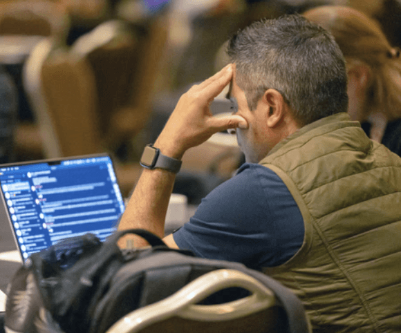 A person looking at code on a laptop