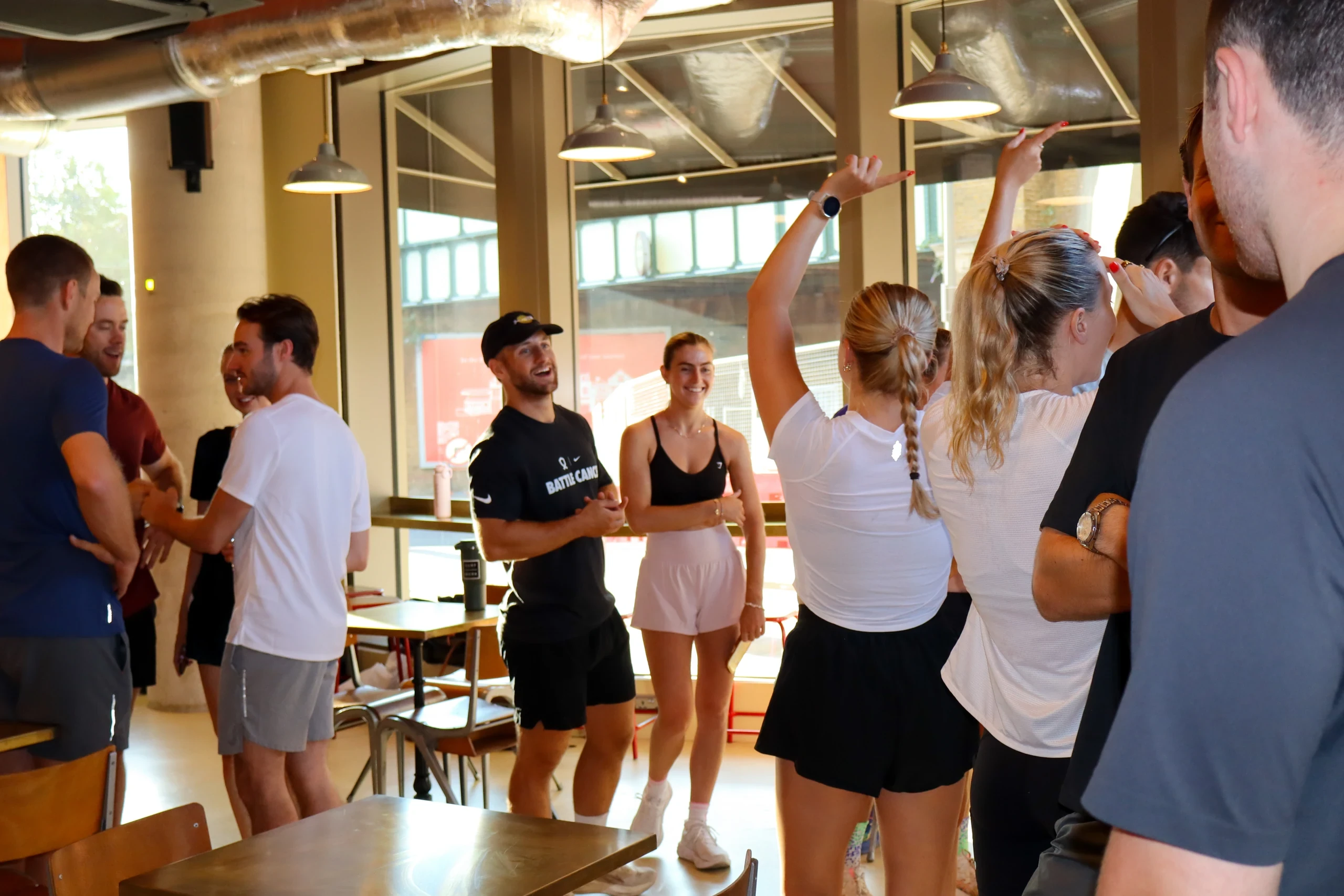 Colleagues in activewear chatting together in a café
