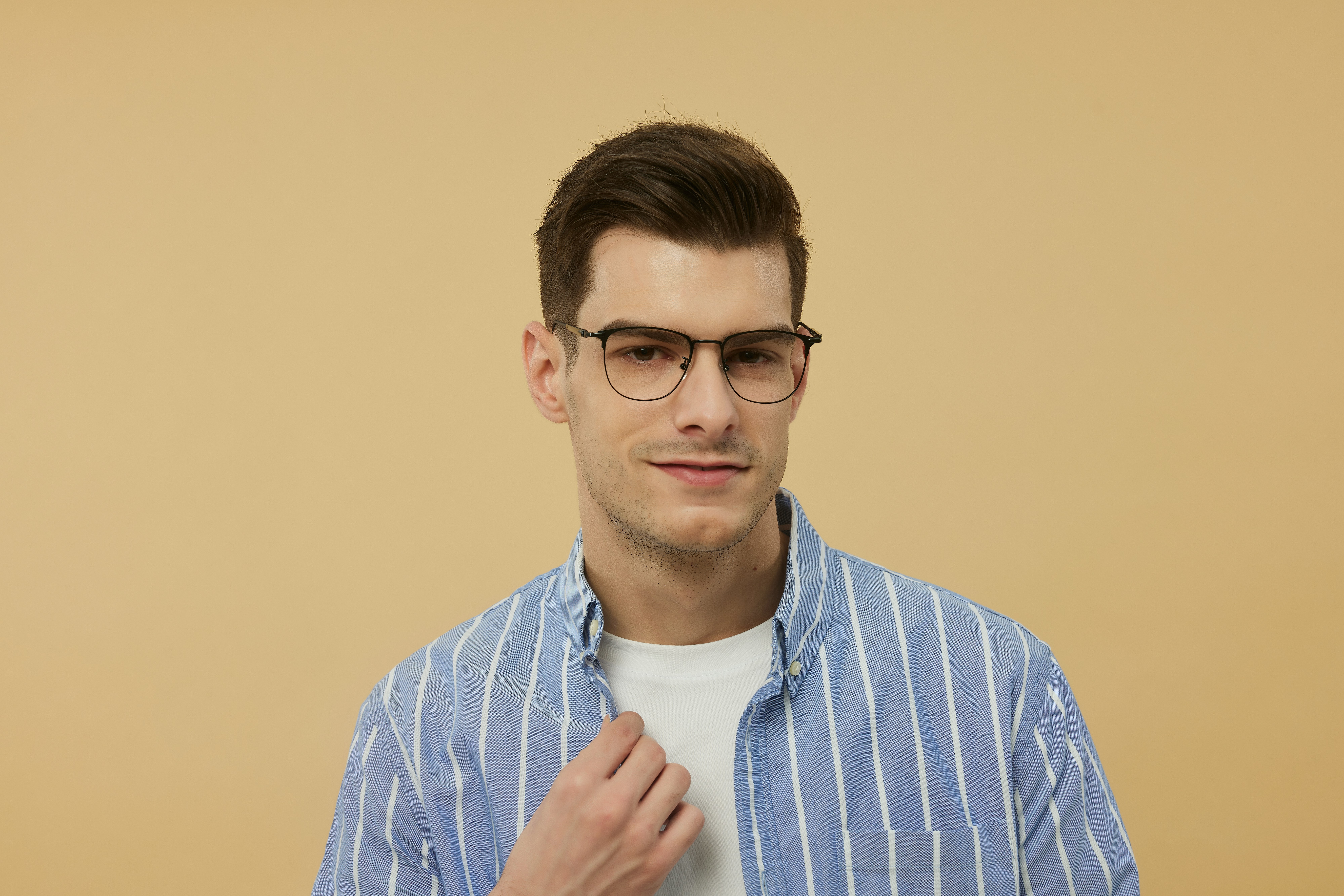 A man wearing glasses and a blue striped shirt