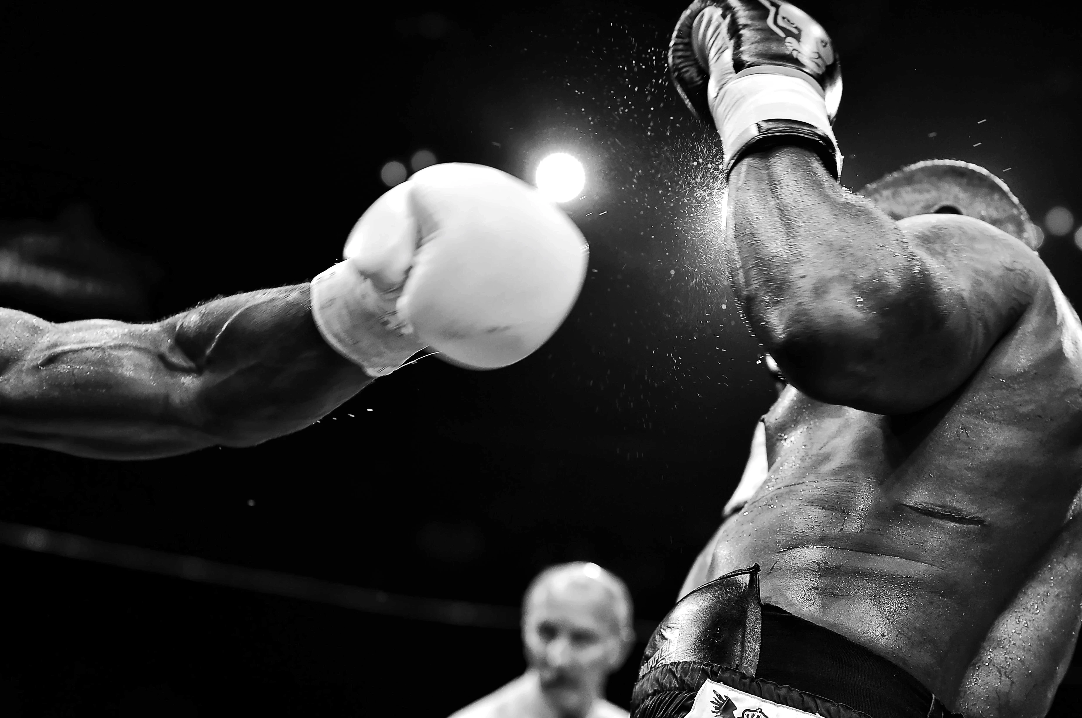 A boxer getting punched squarely in the face, sweat and energy captured mid-impact, embodying the intensity of the fight. The perfect visual for illustrating the phrase 'placed on a pip' with raw power and determination.