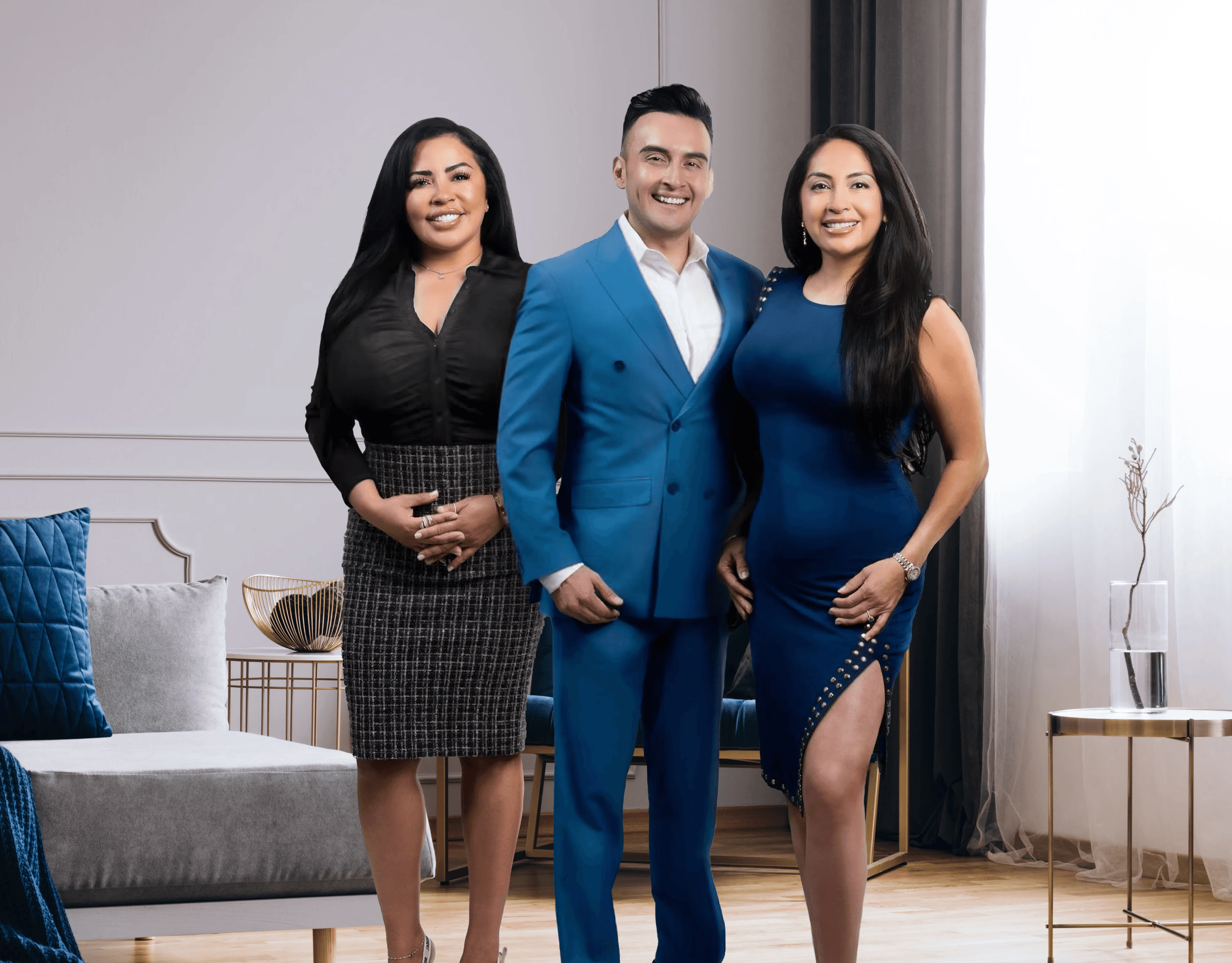 Three people sitting on a couch in a room looking at mobile devices