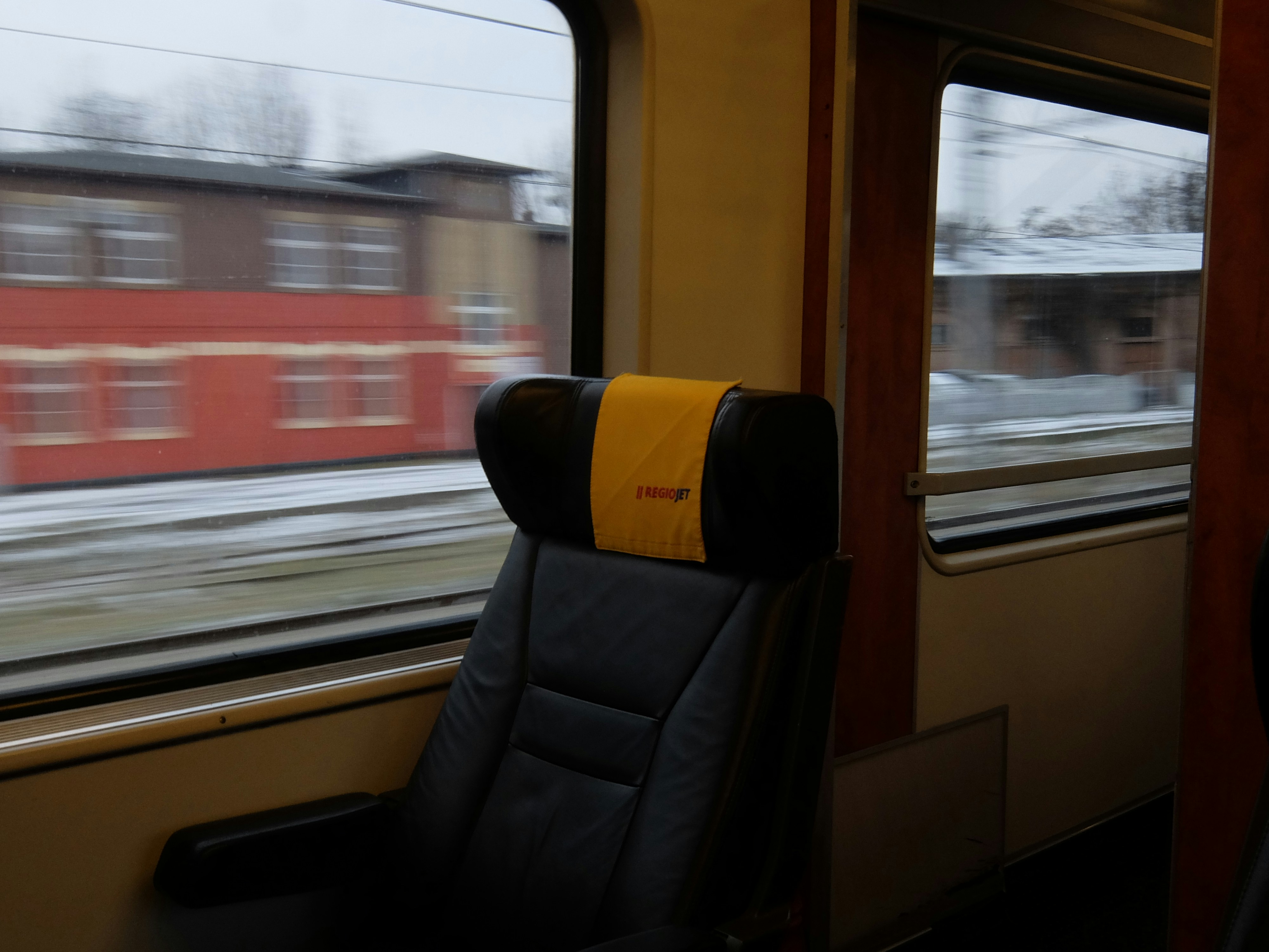 Interior view of train seat with passing scenery