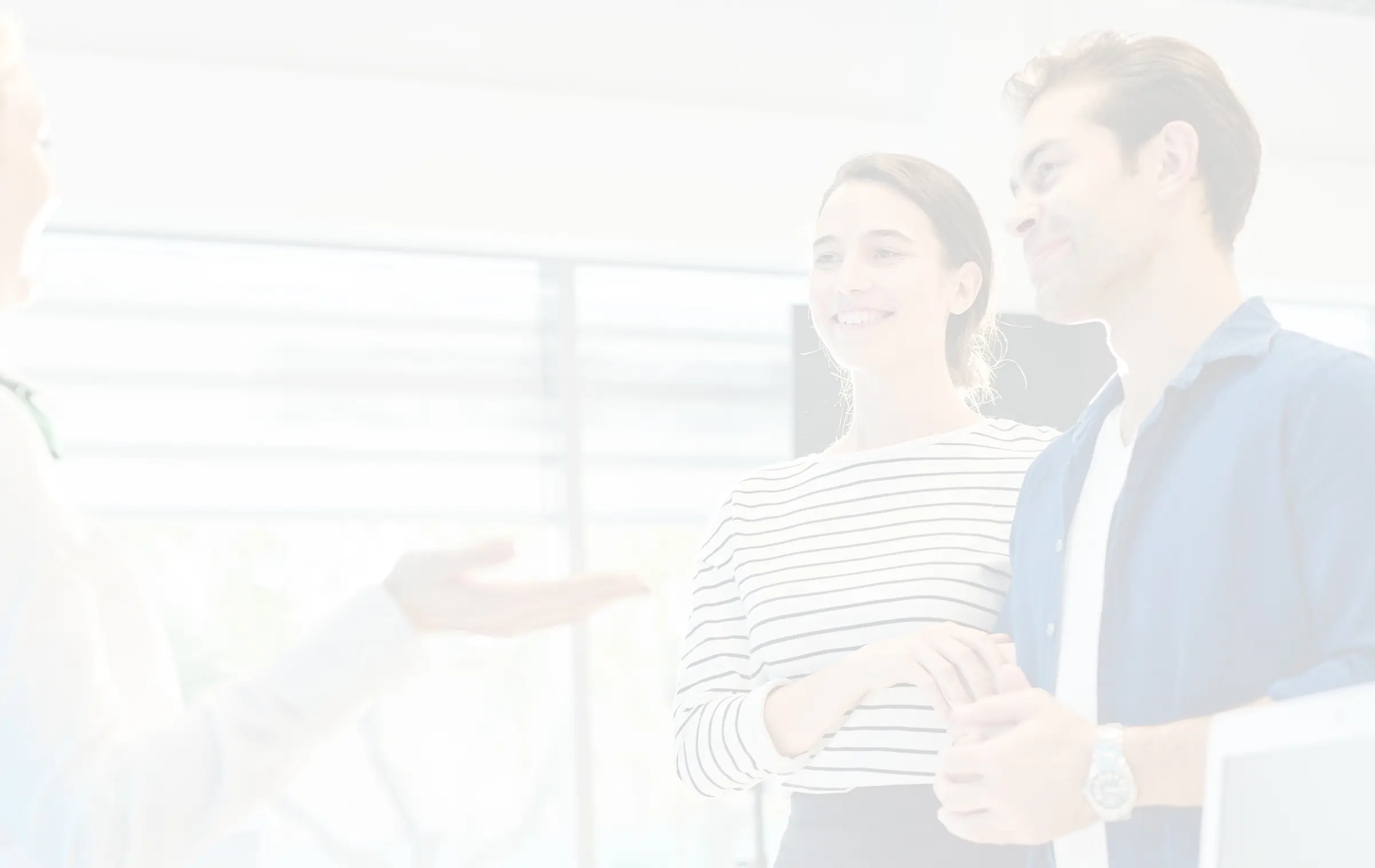 Couple being greeted by receptionist at Wellness clinic.