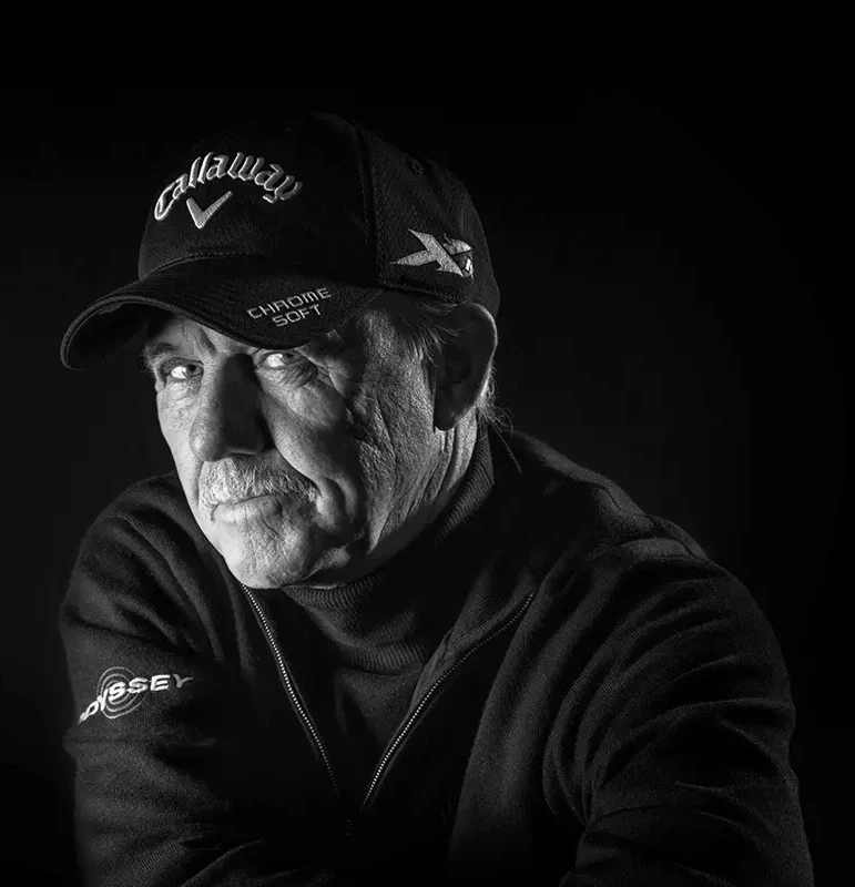 Black-and-white portrait of a golf coach