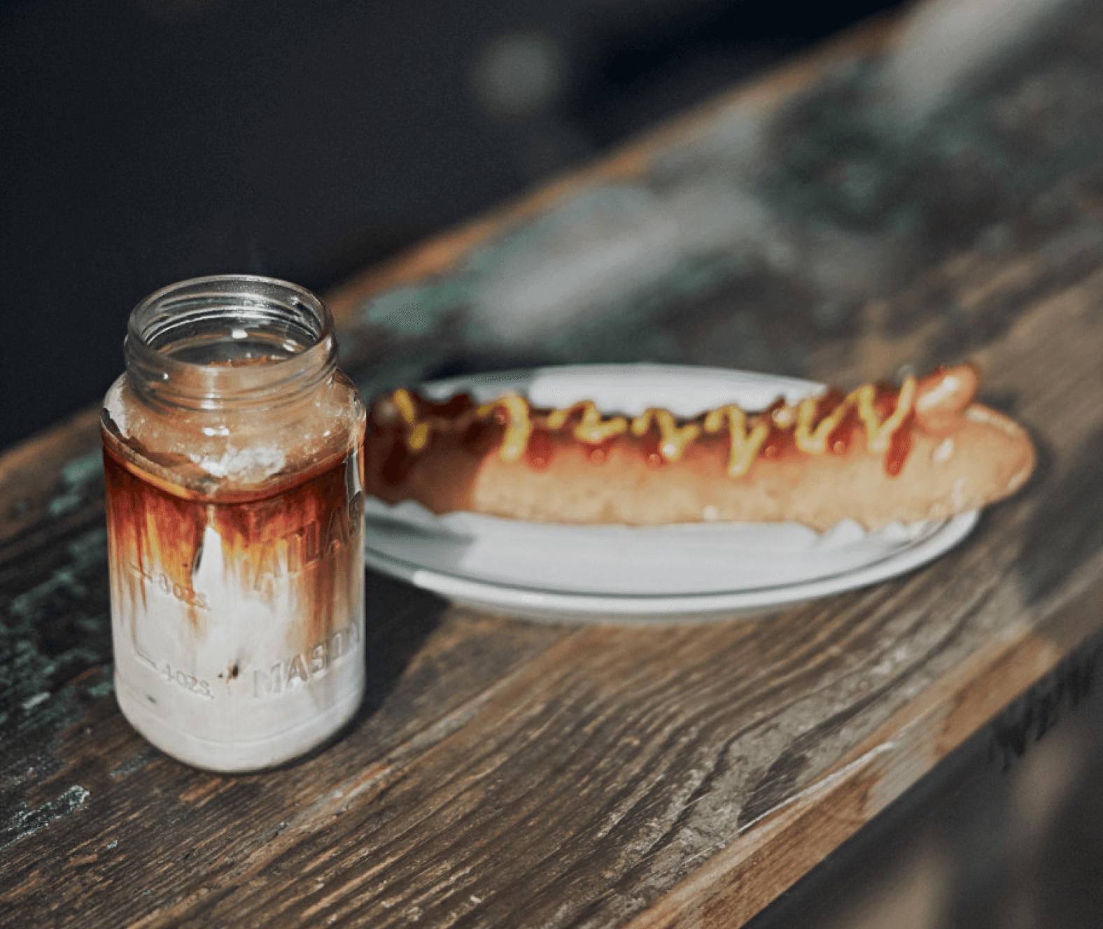 coffee and hot dog on an ourtoor bench - photo by little nap coffee stand