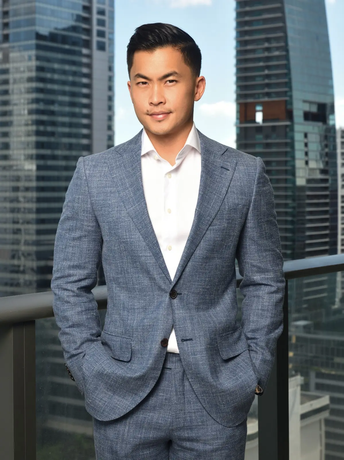 A girl in a sunflower field holding up a camera to take a photo