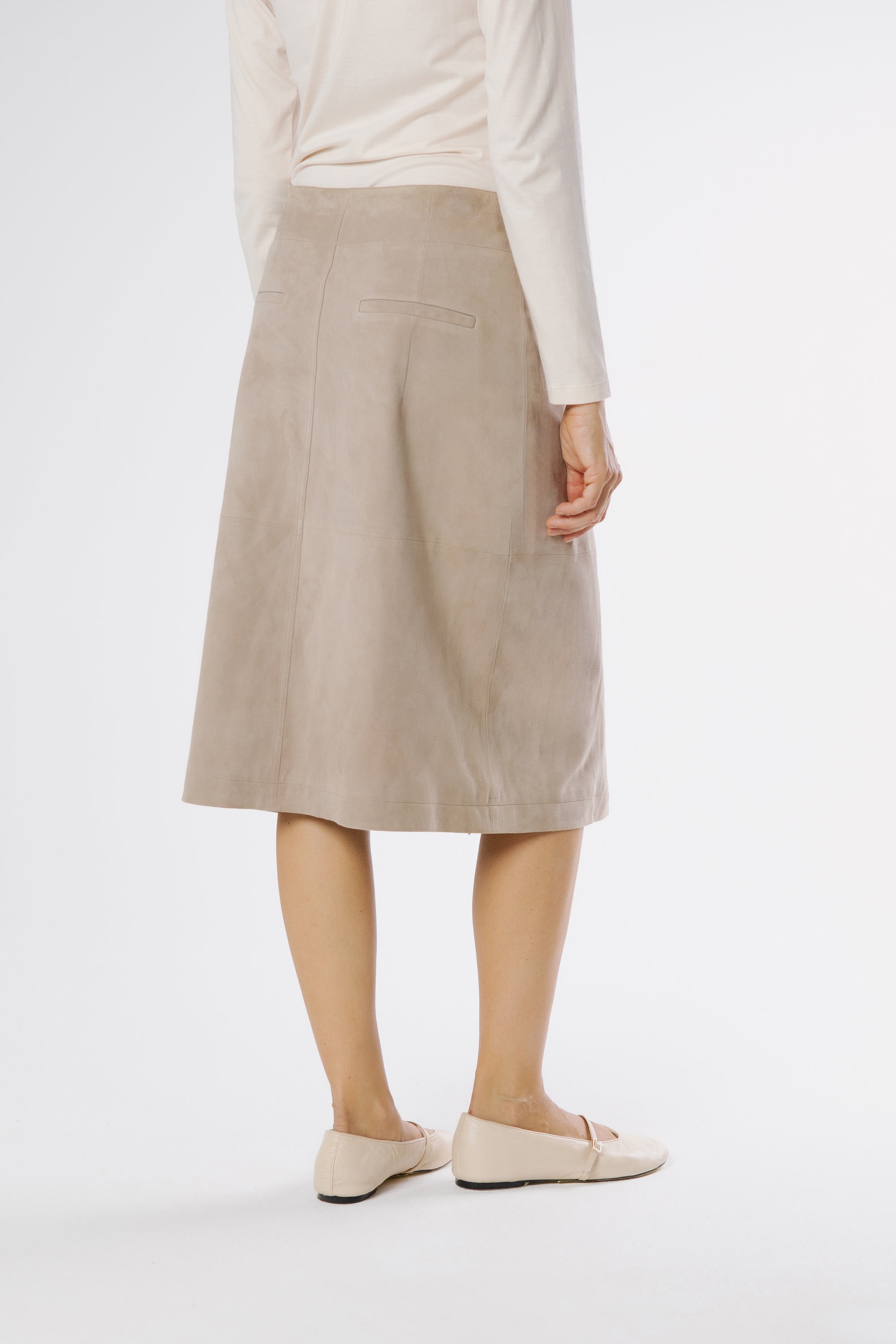 Back view of Danny suede wrap midi skirt in Nougat, showing the smooth rear panel and refined, elongated silhouette.