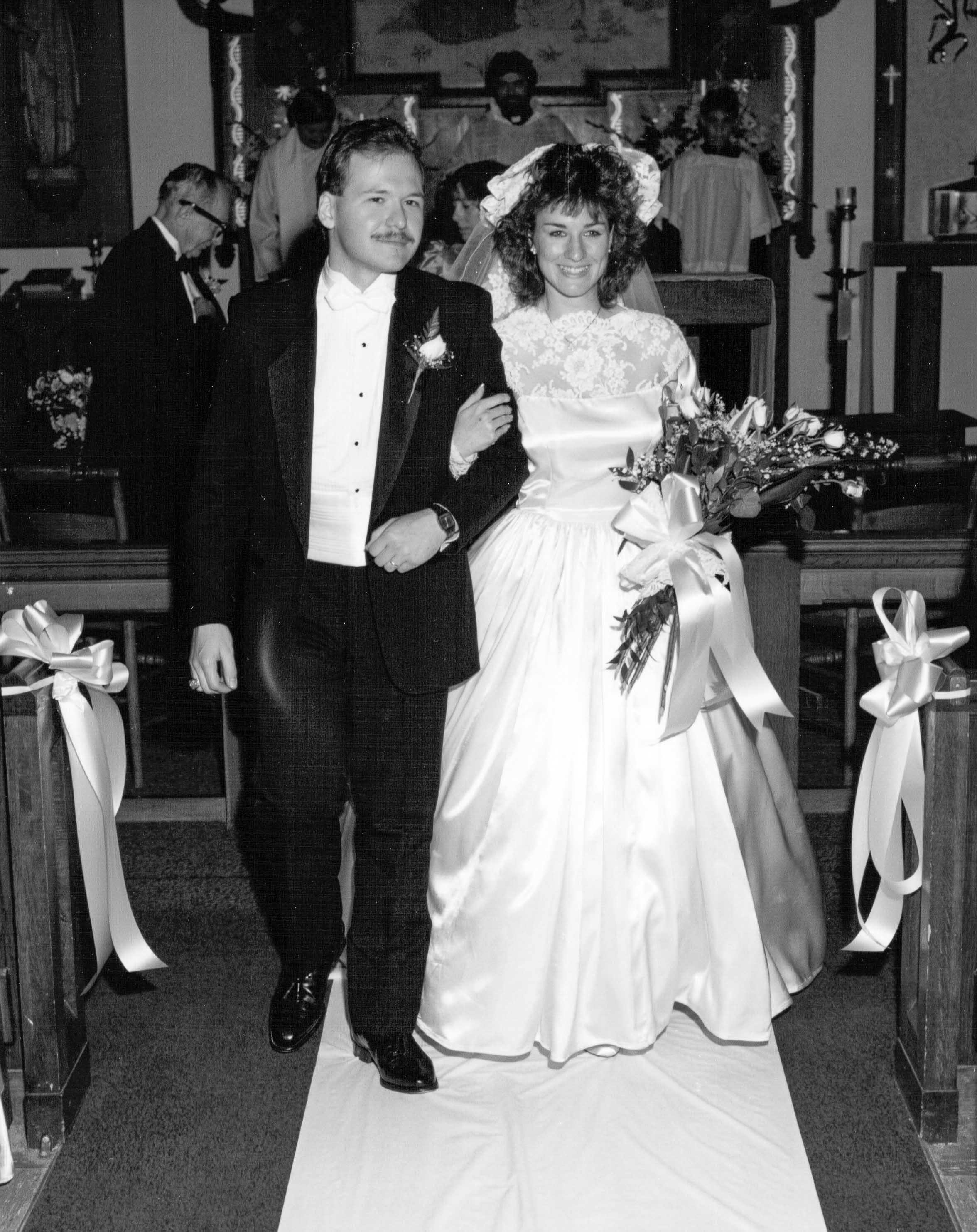 Black and white image of old family photo of parents on their wedding day.