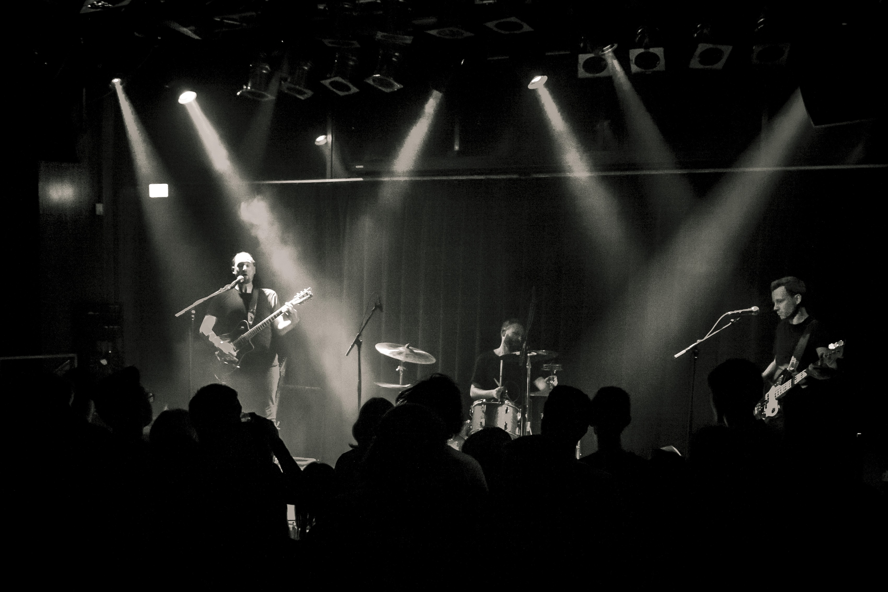 Performer under spotlight on dark stage