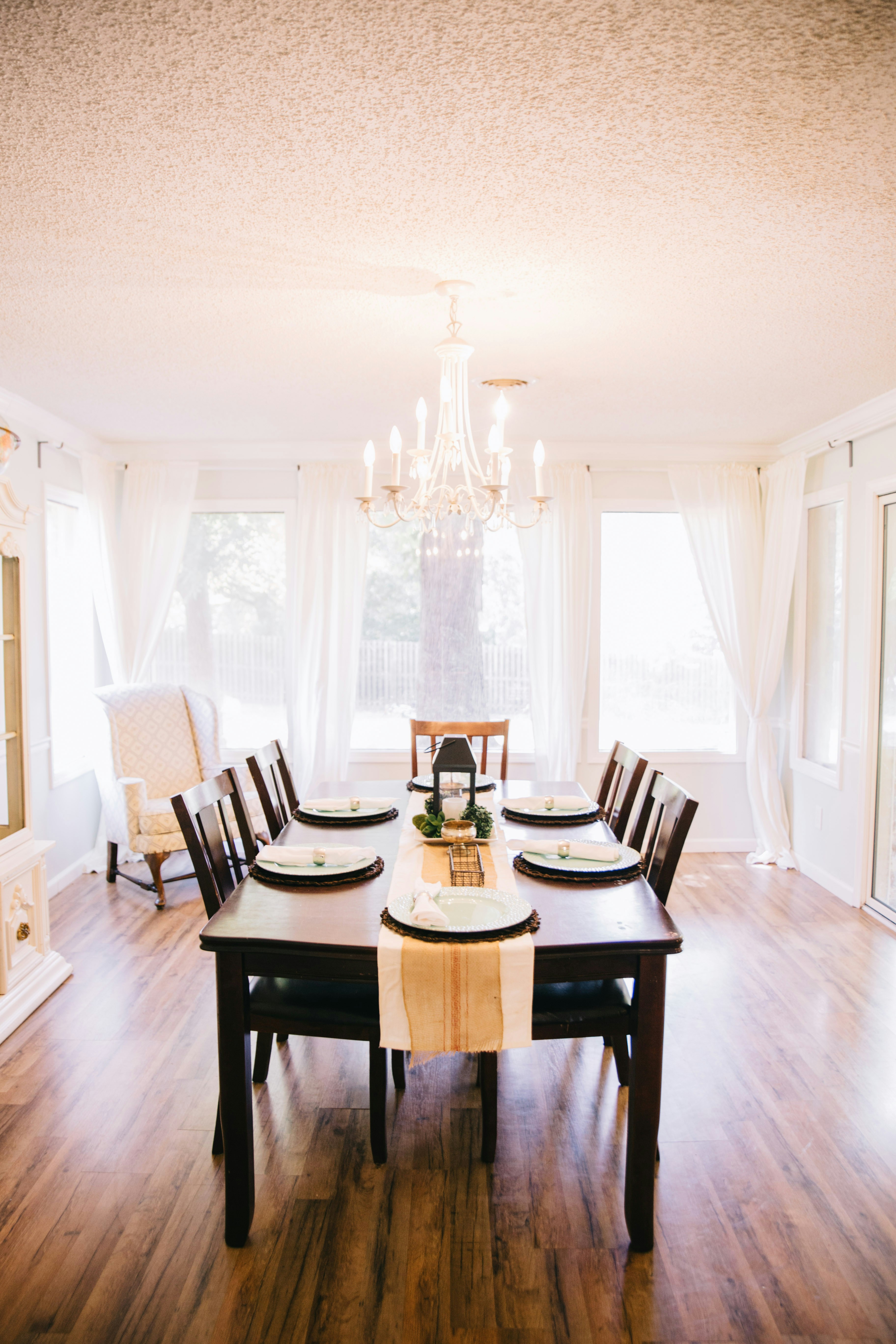 Formal dining room with a chandelier and a large table.