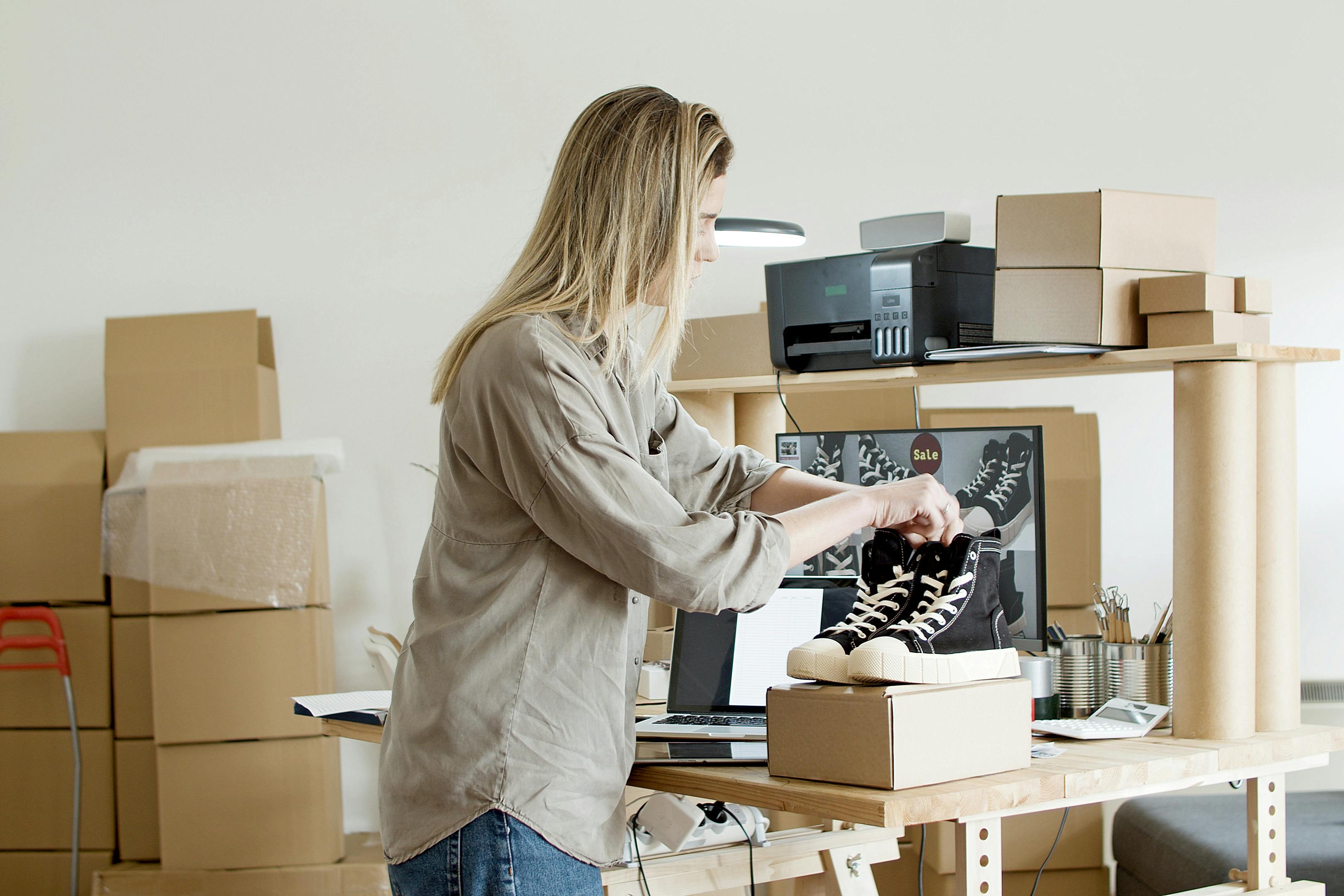 woman shooting product photos for her ecommerce platform of her shoes