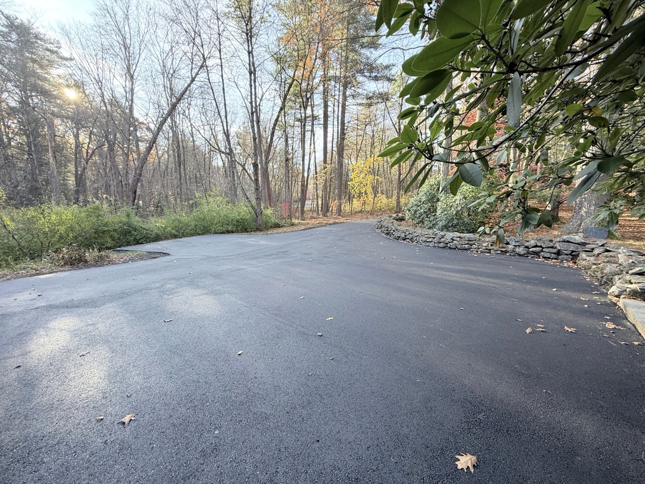 Long wooded driveway freshly paved, A&M Construction