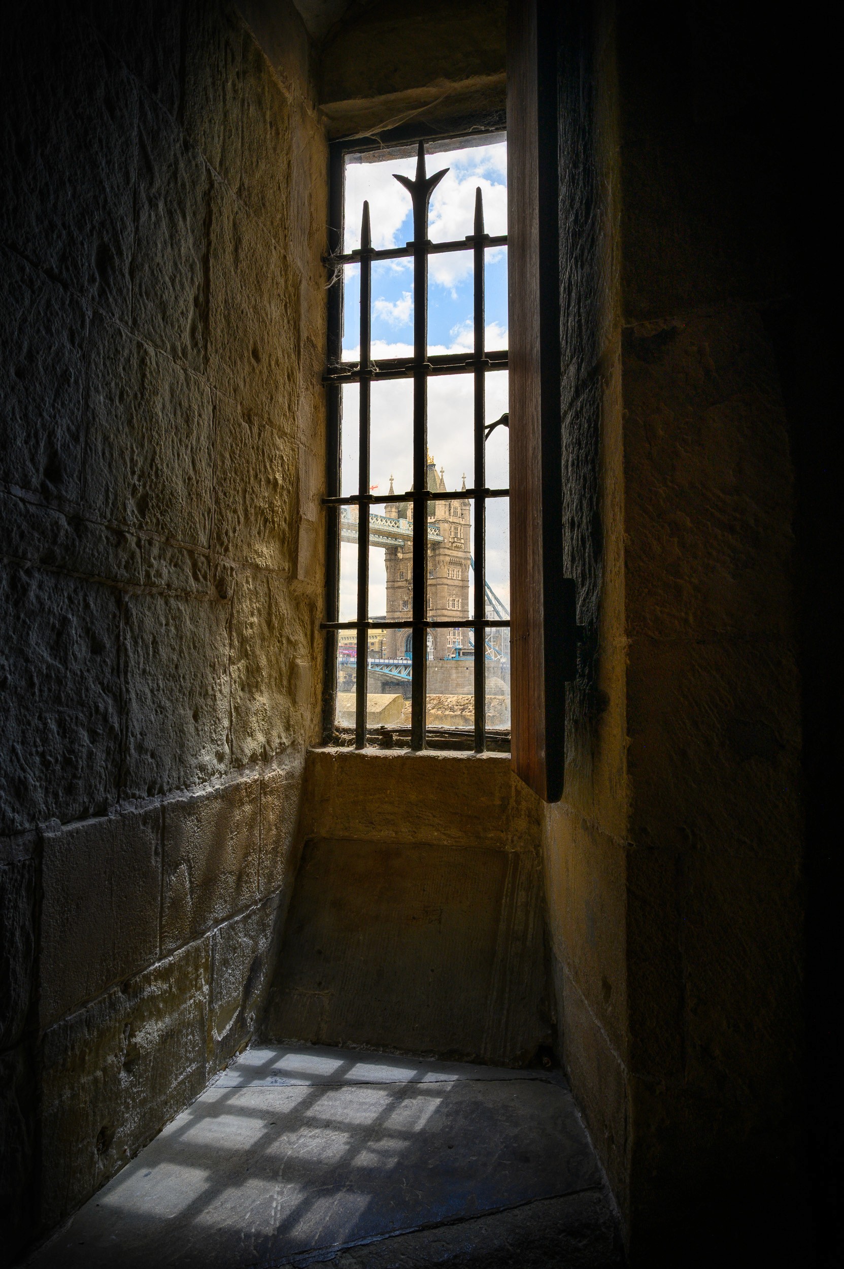 Light coming through the window with a view of Tower Bridge, London, UK