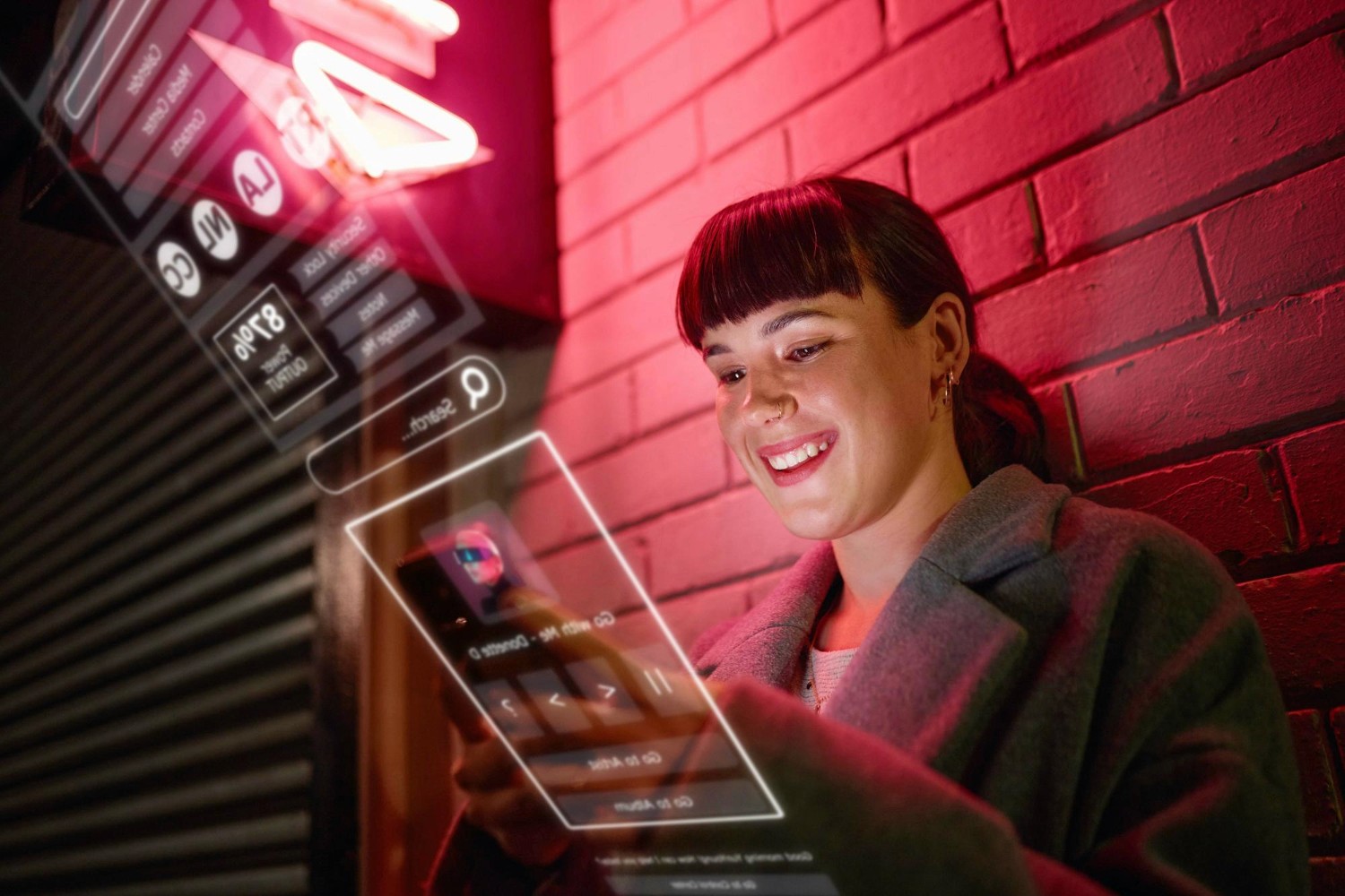 A woman gazes intently at her phone screen, illuminated by a vibrant neon sign in the background.