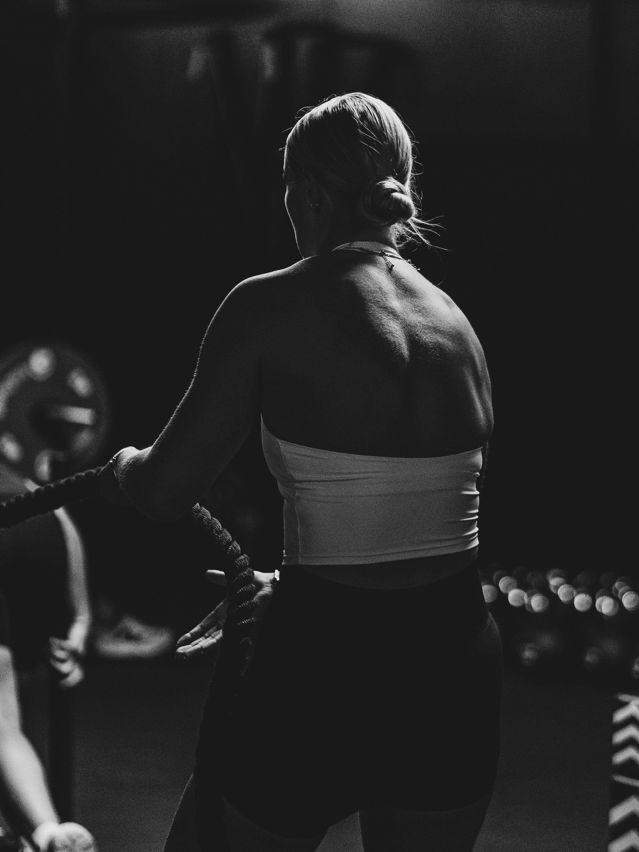 A man with ear buds in a gym