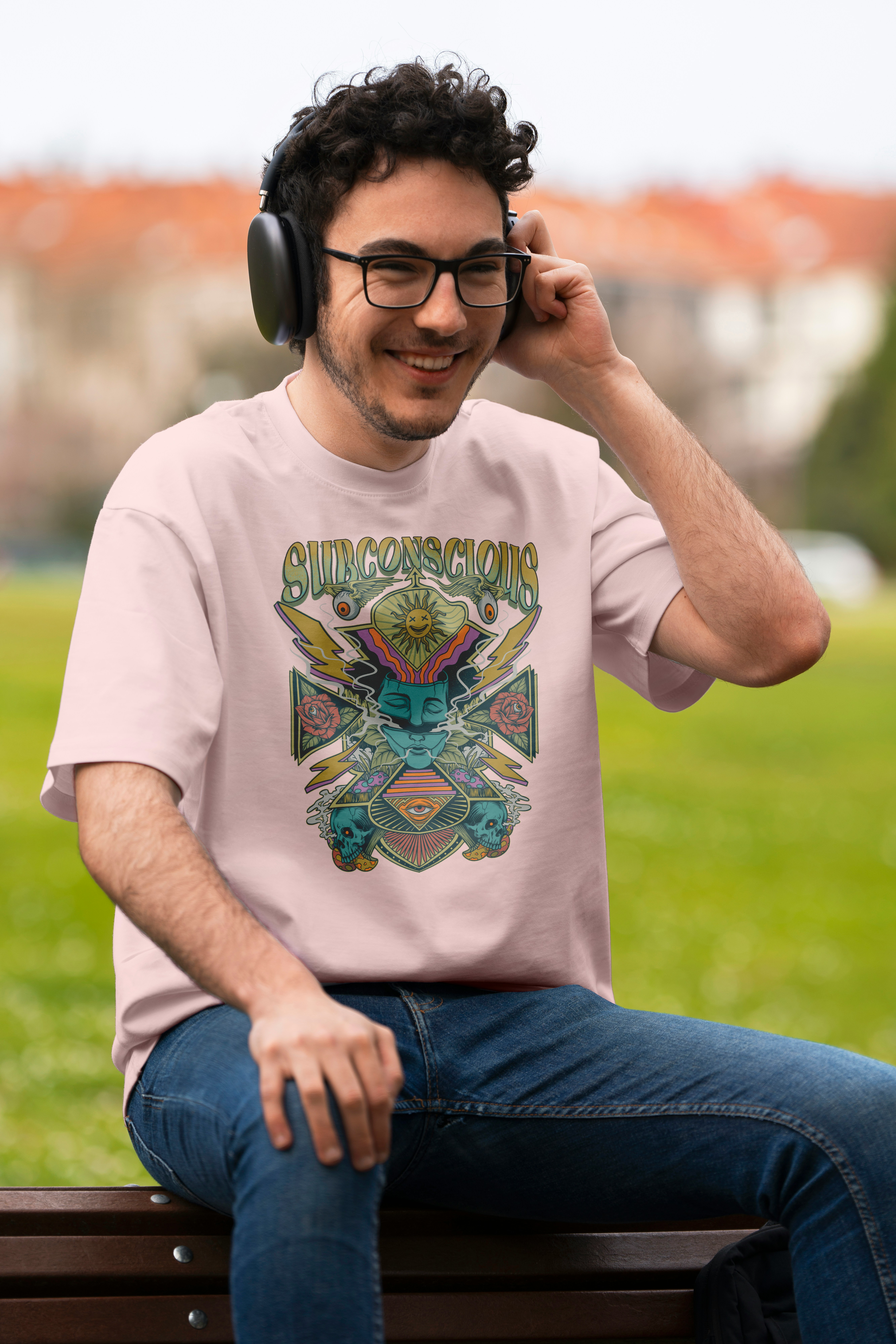 Man wearing headphones and a graphic t-shirt outdoors