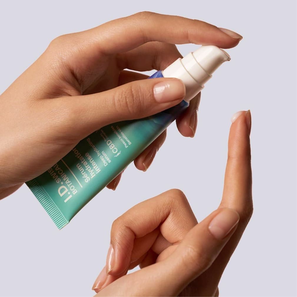 I.D. Swiss Botanicals serum being dispensed onto finger illustrating product usage and skincare routine