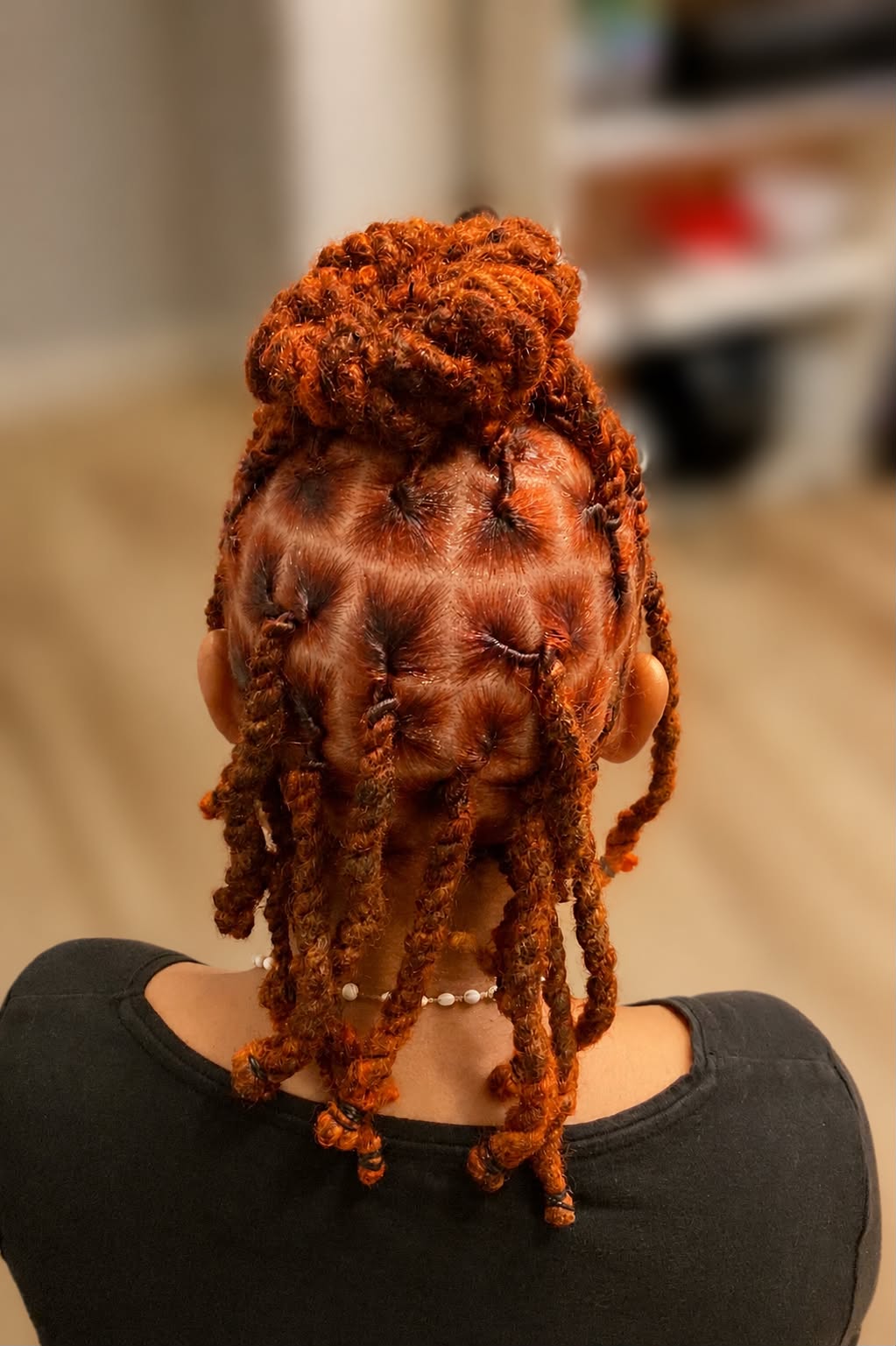 a woman getting her hair cut by a hair stylist