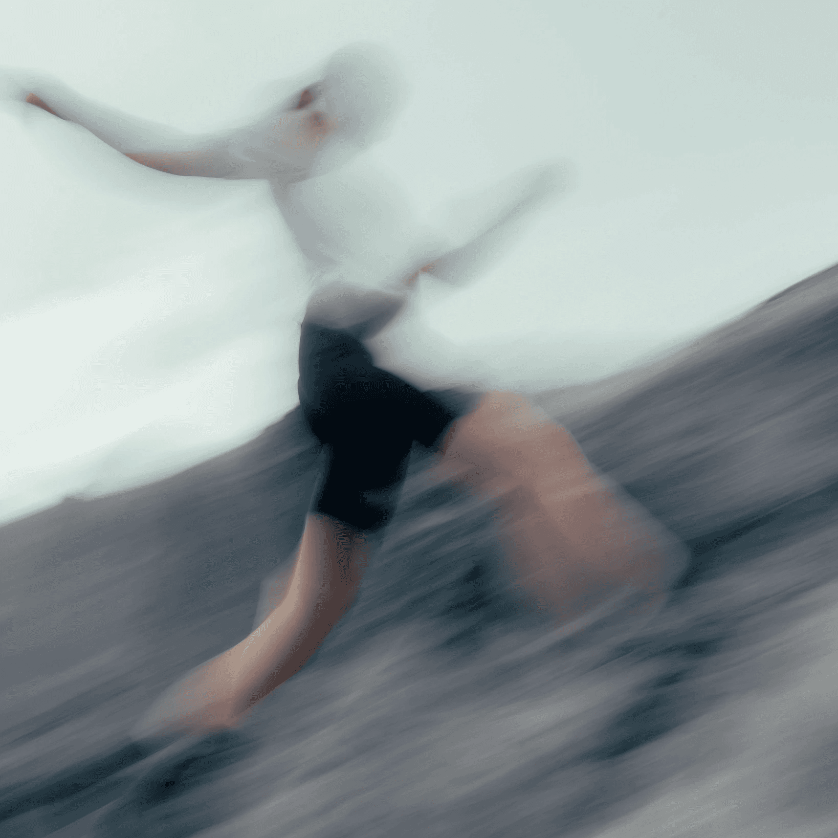 picture of a woman, running, in the mountains, jumping over the river.