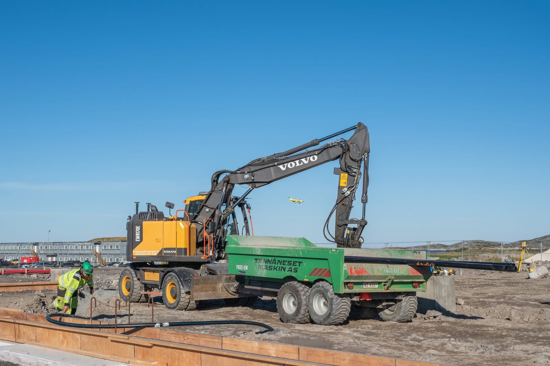 Grå lastebil med svart henger.