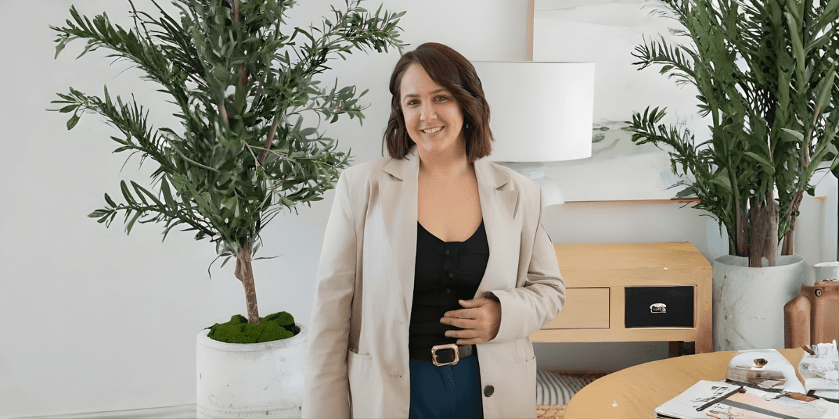 Iluka Cindi Greentree, founder of Hustle & Grace, in a stylish, coastal-inspired setting.