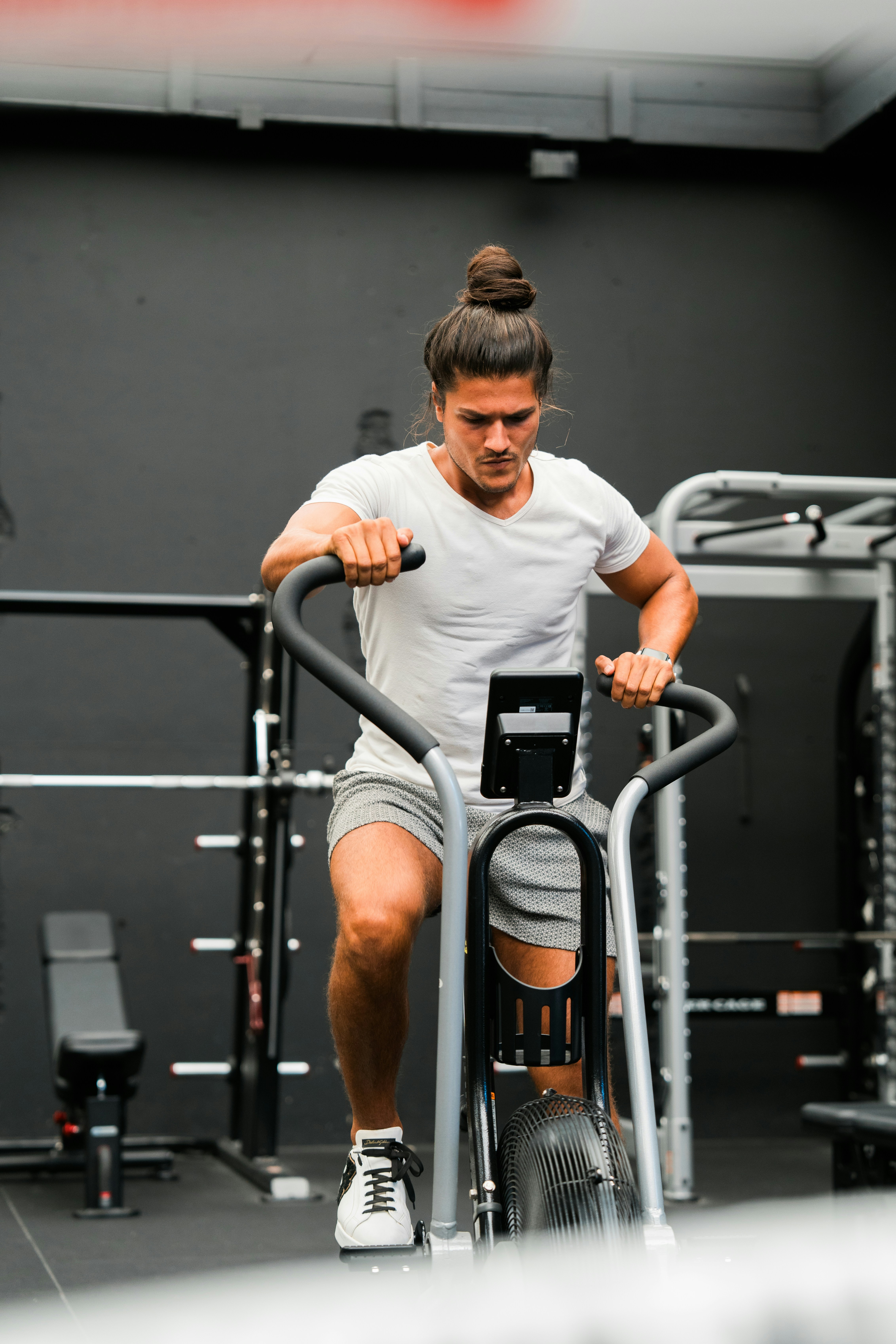 A man on a stationary bike in a gym
