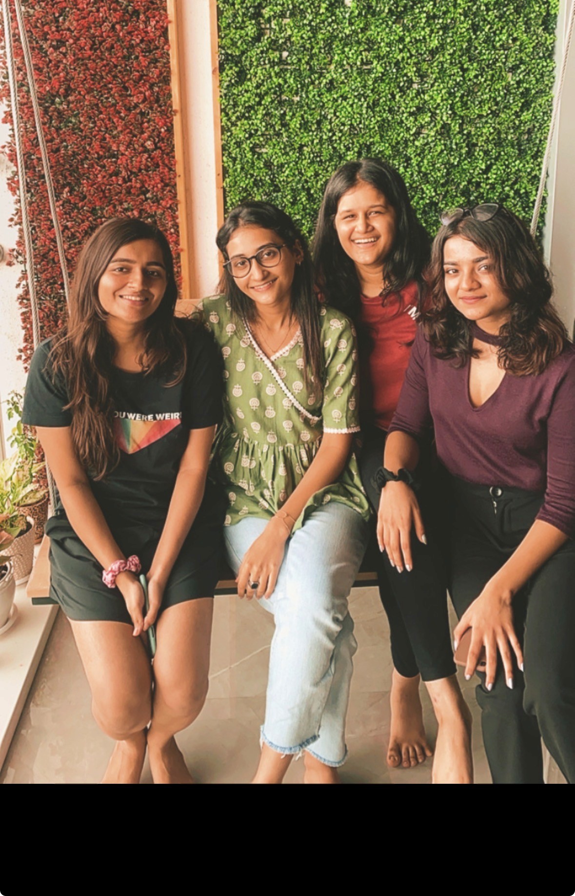 Symmetrical abstract pattern of dark, curved shapes.