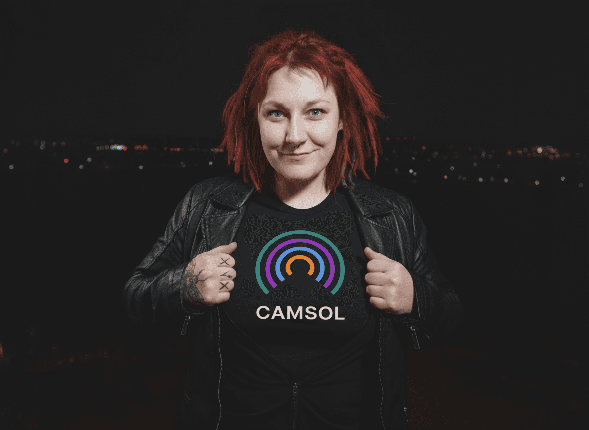 Annika Rothe wearing a black Camsol t-shirt, smiling confidently with the Camsol logo glowing in the background.