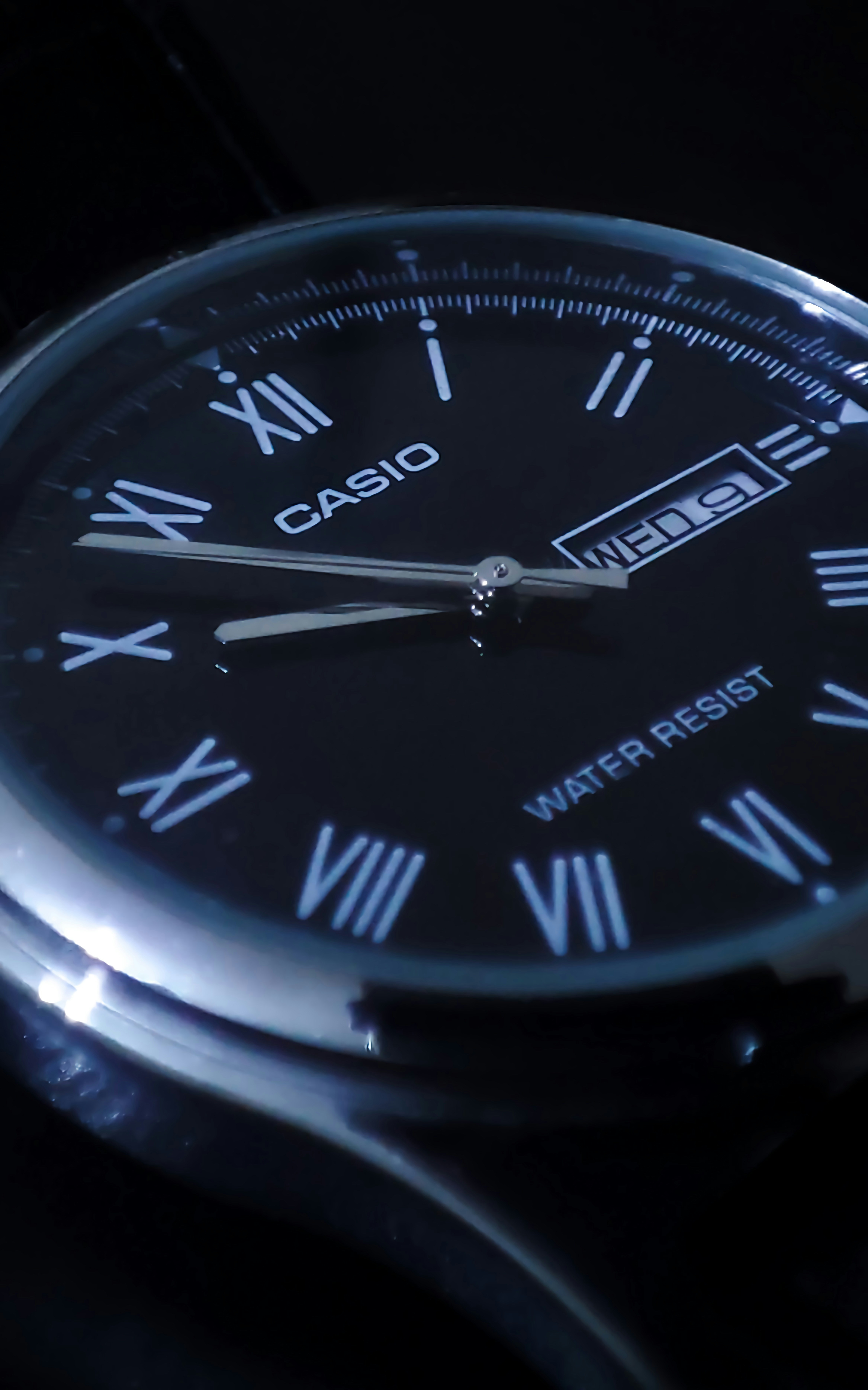 a close up of a wrist watch with roman numerals