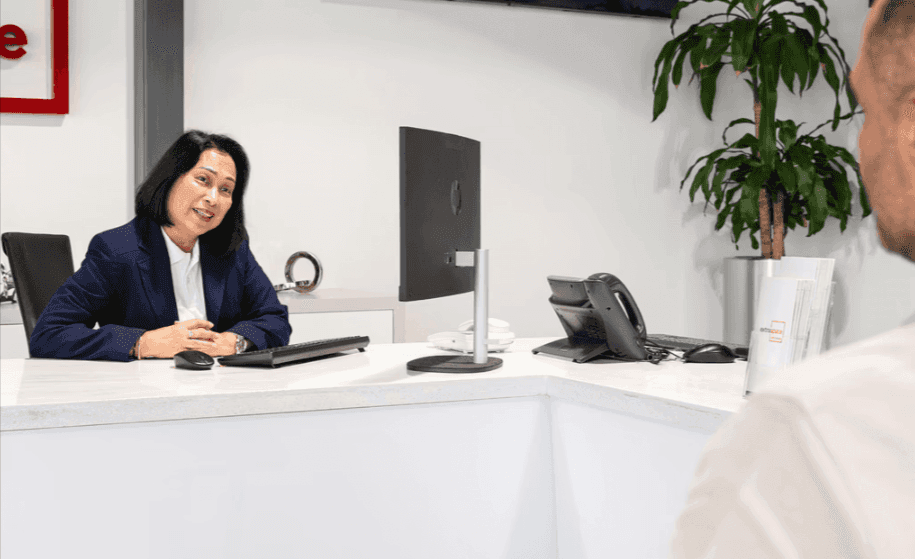Woman in sales and marketing speaking with a commercial storage worker